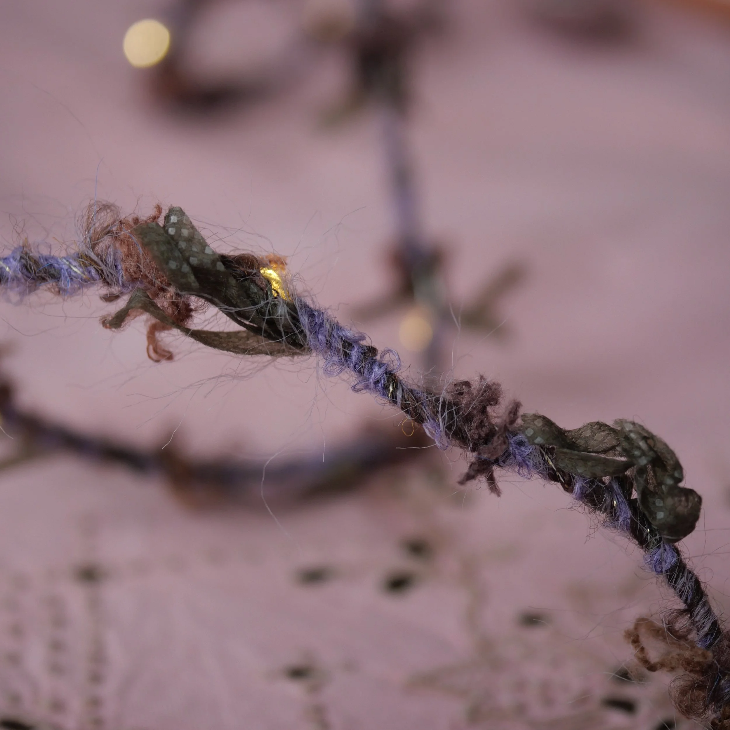 Heather Hedgerow Fairy Lights with purple and green textured yarn and warm white LEDs