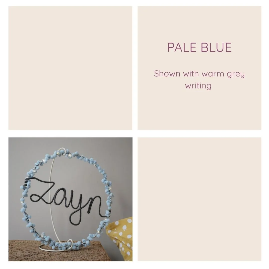 Pale blue personalised hoop light examples with different writing colours