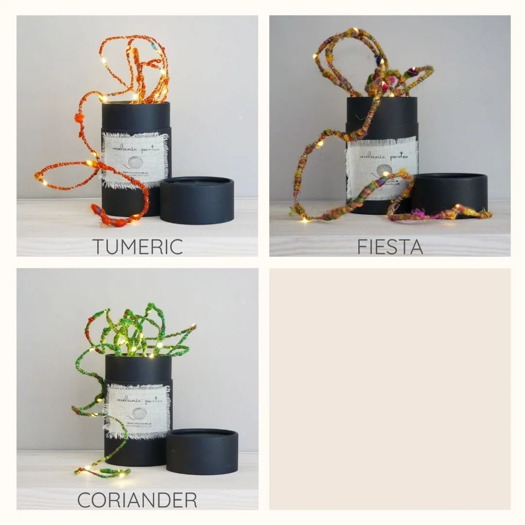 Turmeric, Fiesta and Coriander sari silk fairy lights shown with gift boxes