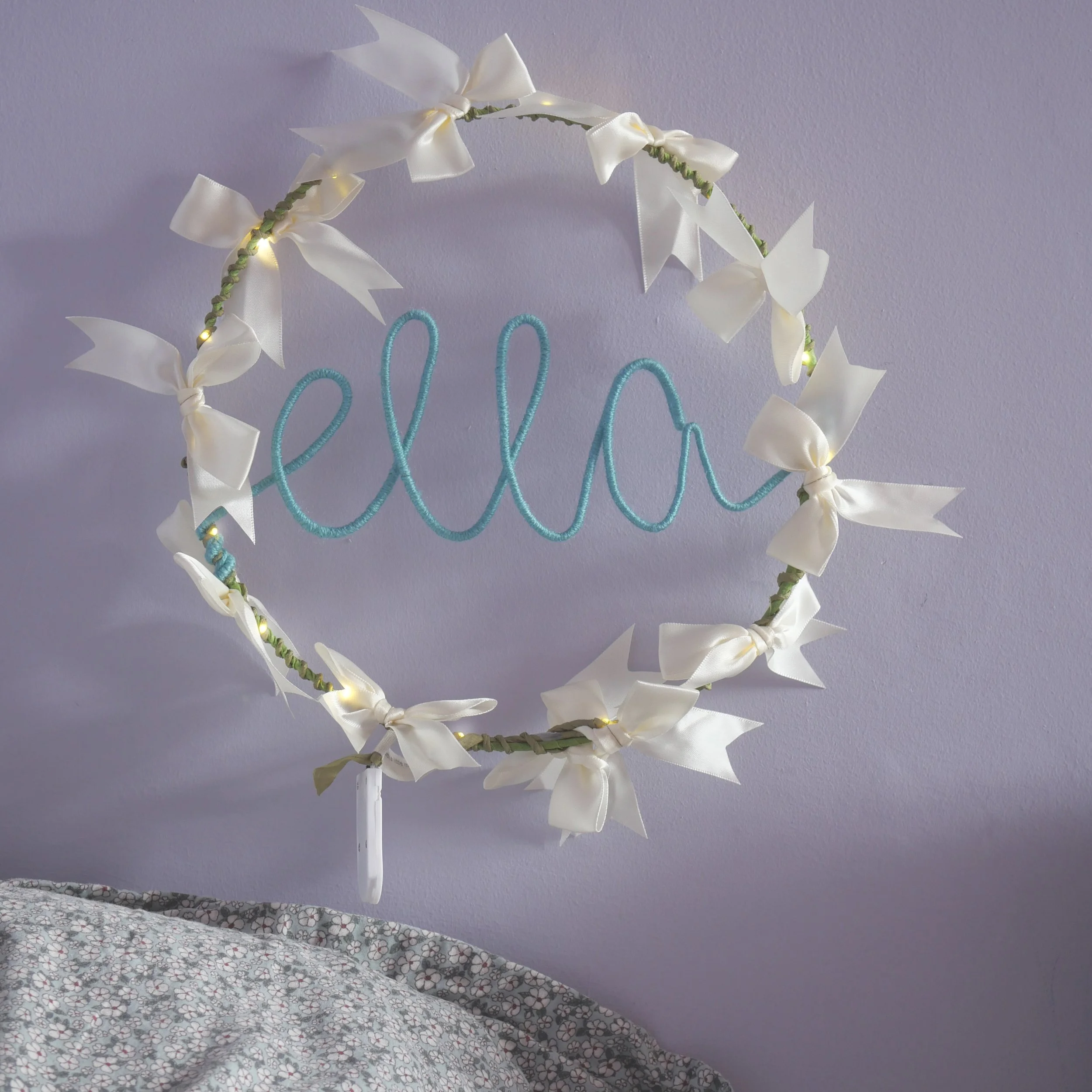 Personalised name light with ivory satin bows, olive green hoop and Ella written in duck egg blue yarn.  Copy