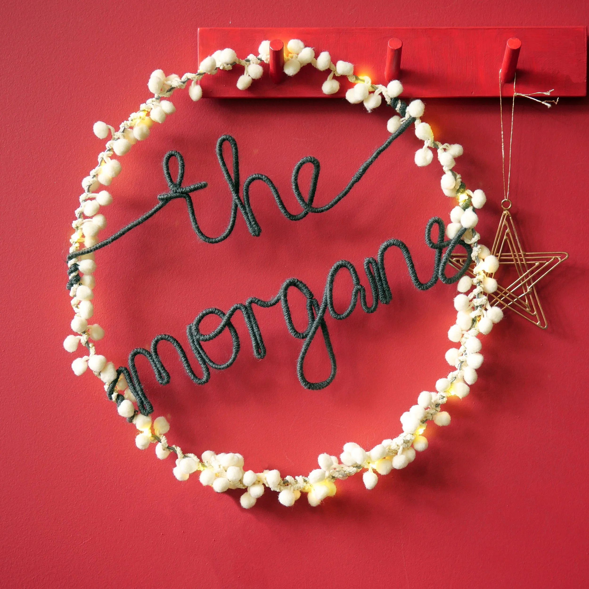 Personalised white pom pom Christmas wreath with family name