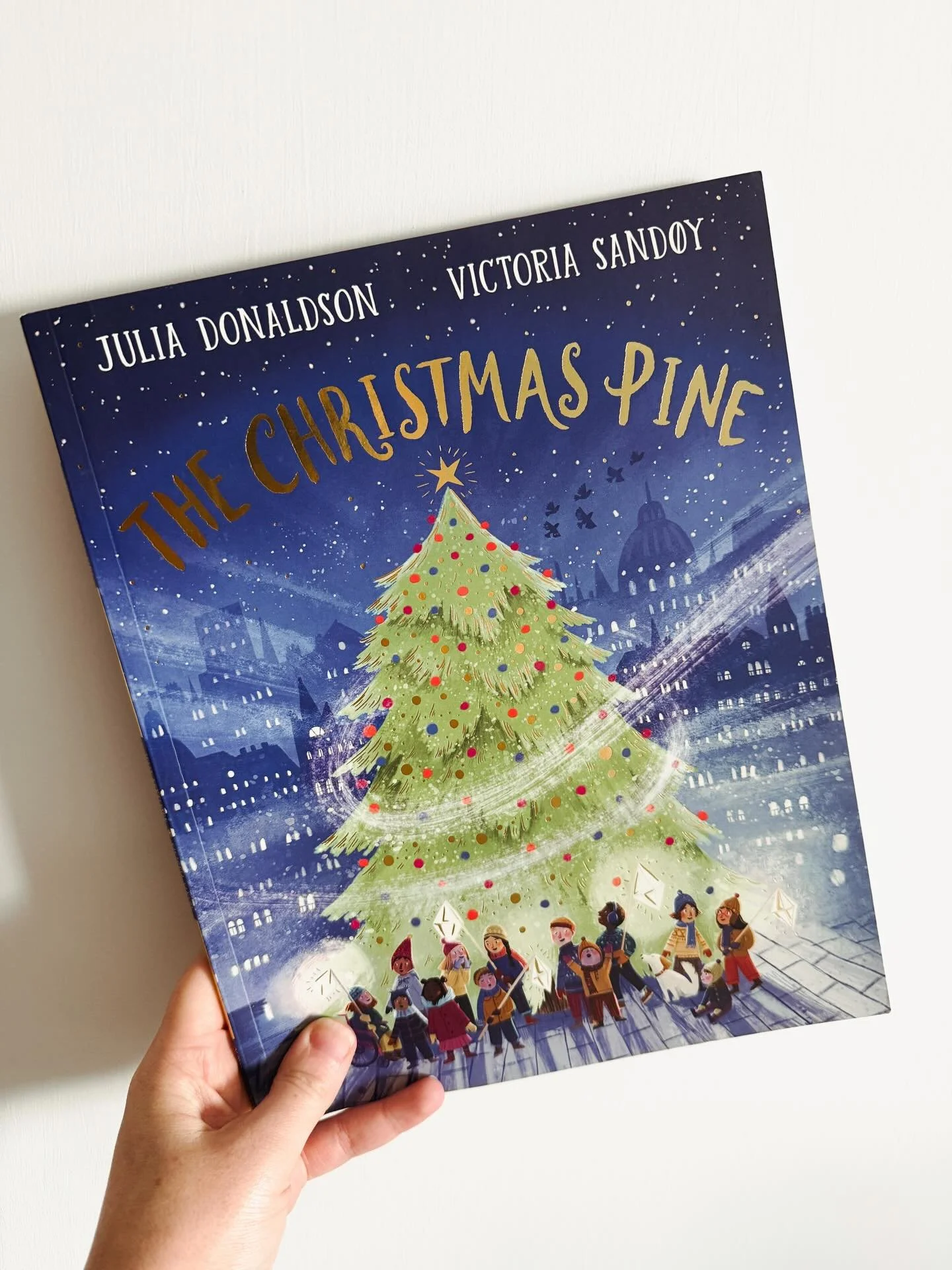 Everyone in the house is poorly at the moment and I&rsquo;ve fallen behind with sharing some of our favourite Christmas books.
This one we opened in our advent yesterday, it tells the story of the pine tree the UK receives from Norway each year as a 