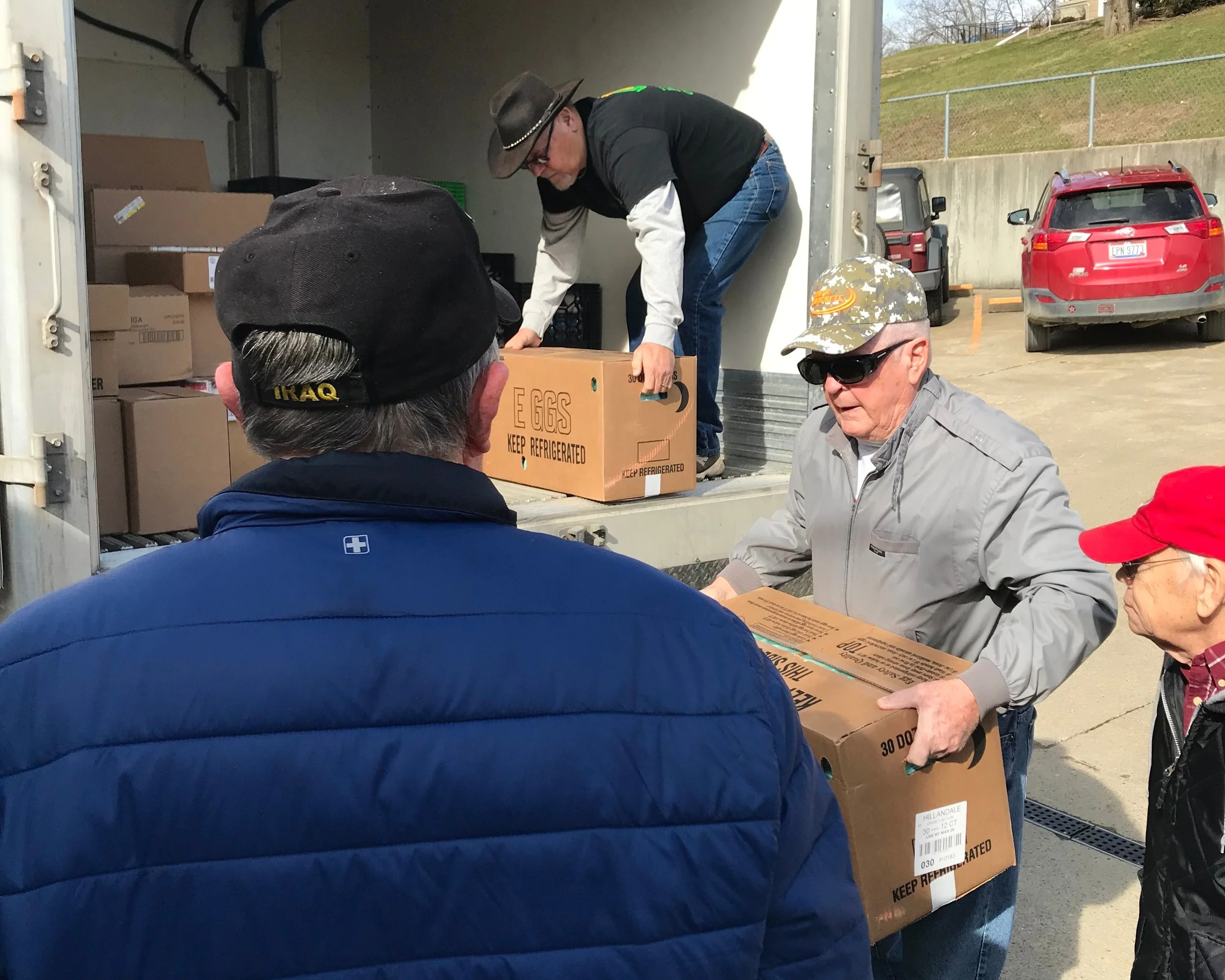 Several volunteers from Harvest of Hope and Tri-County Food Pantry unload over 700 lbs of donated food.