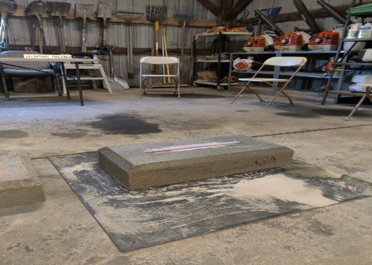He constructed bases for the headstones in the shop.