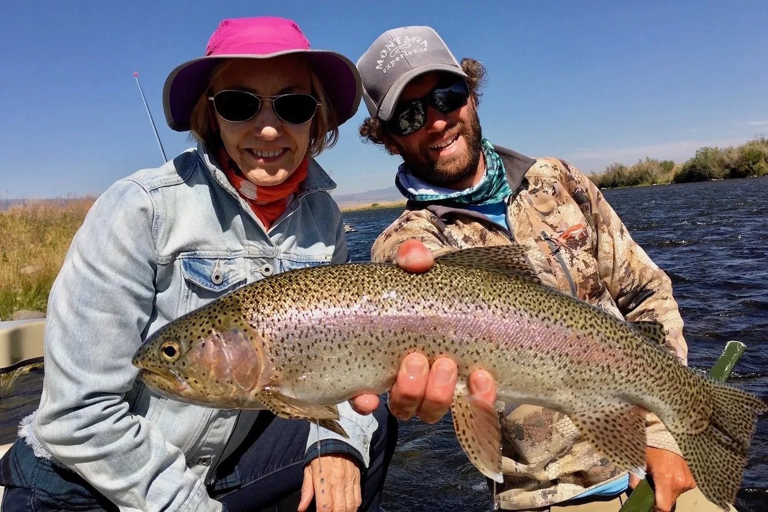 Guide David Kern and a happy client displaying a healthy Madison River rainbow trout during a seamless day of fly fishing near Bozeman.