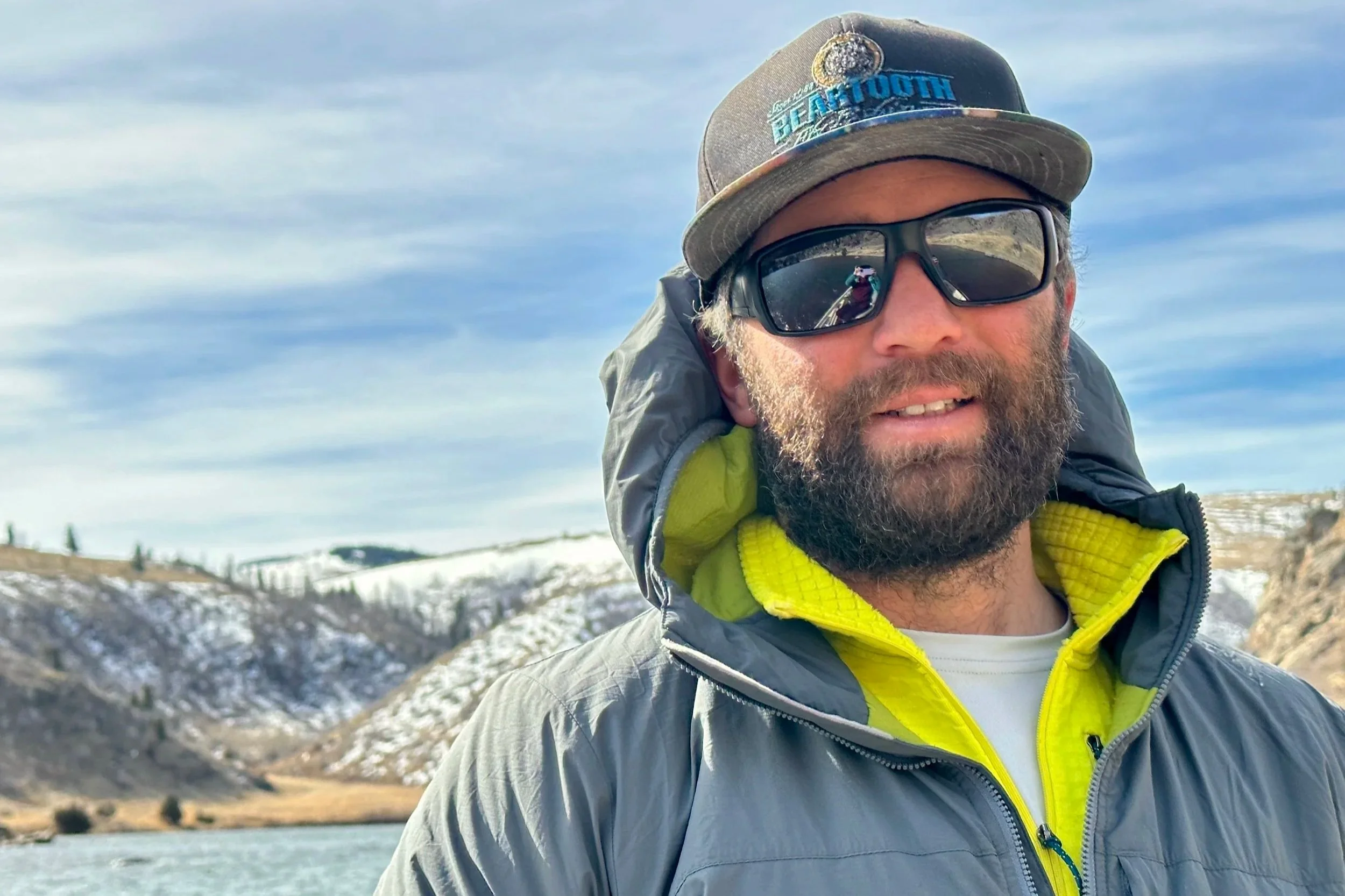 Flyshot Outfitters owner and licensed Montana guide David Kern standing along the Yellowstone River near Bozeman, MT, during a winter fly fishing session.
