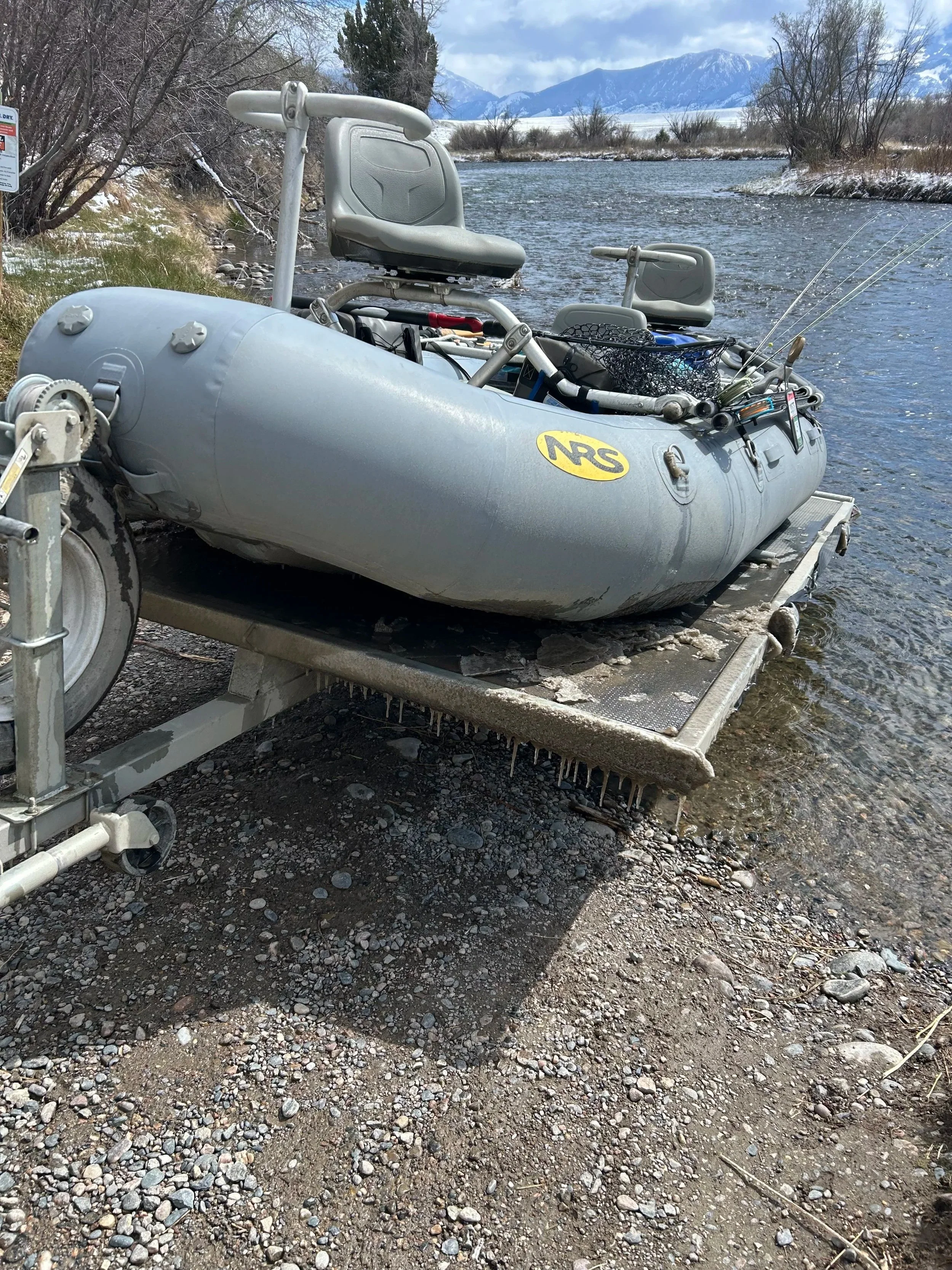 Launching a raft and trailer caked in ice at the 8-Mile Ford boat ramp on the Upper Madison River for a late February fishing report.