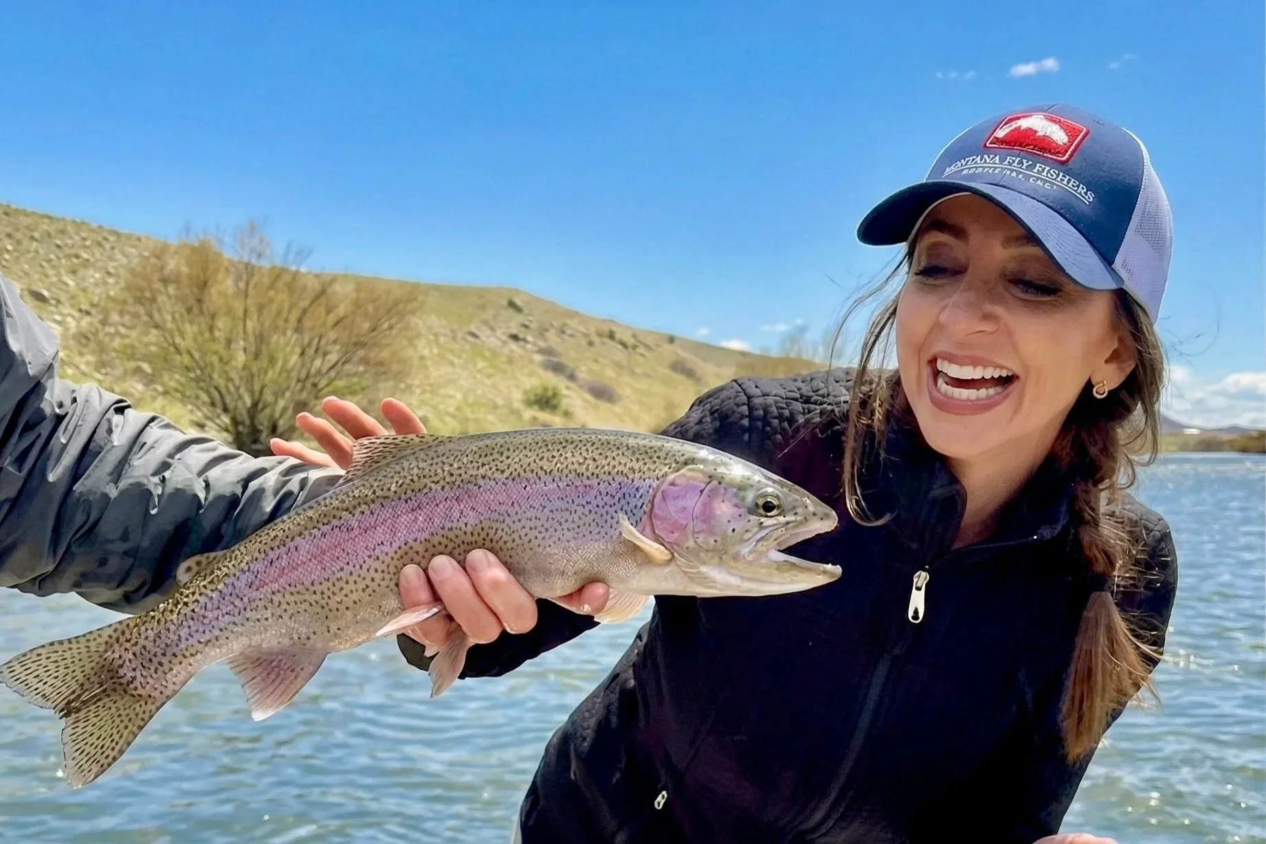 A wild Madison River rainbow trout being showcased during a professional drift boat float trip near Bozeman with Flyshot Outfitters.