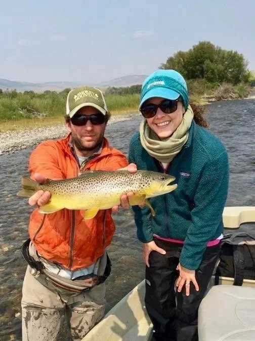 A female client and guide David Kern with a wild brown trout during a premium full-day drift boat trip on the Upper Madison River near the Varney Bridge boat launch.