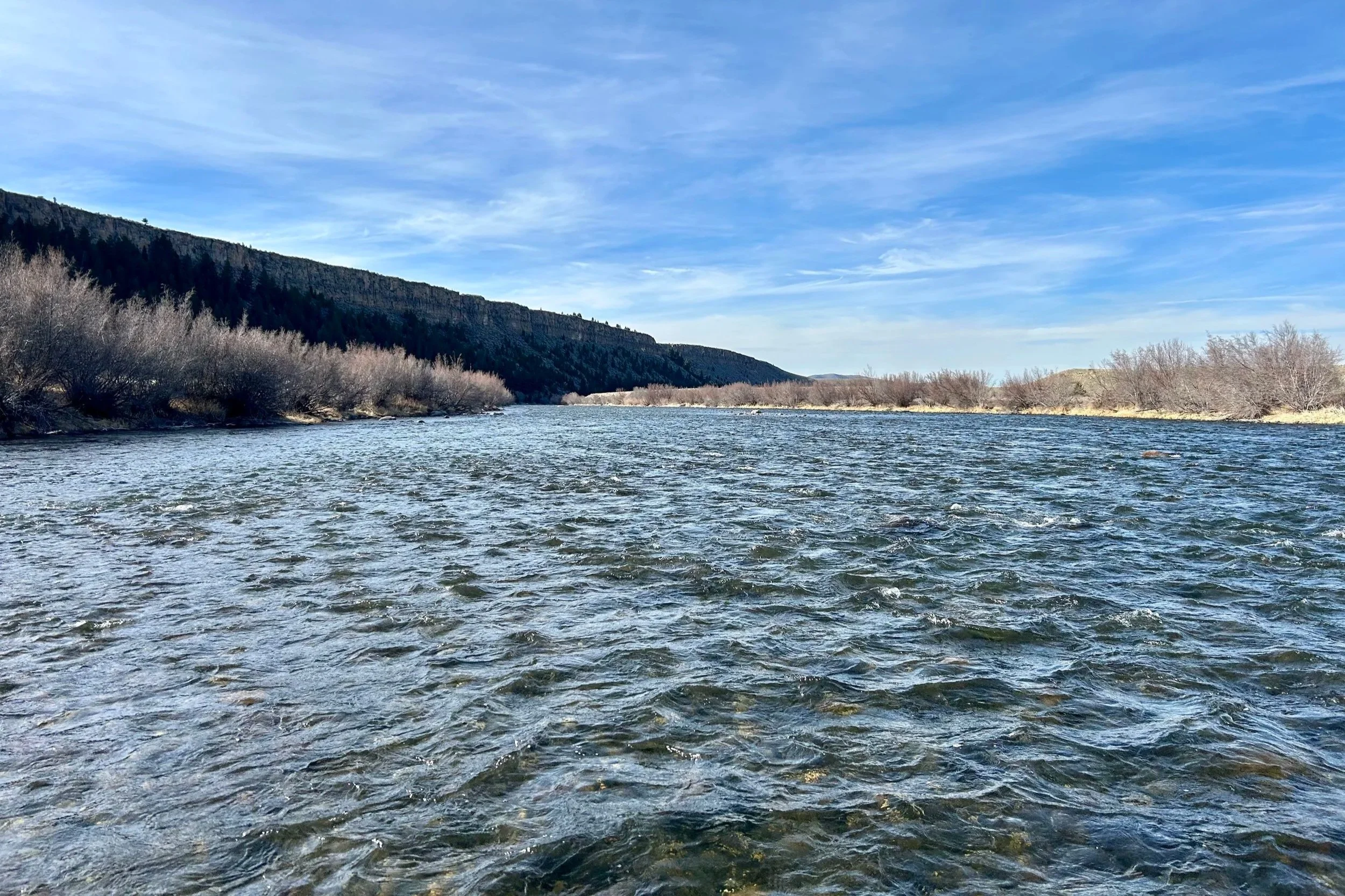 A breathtaking view of the iconic Palisades rock formations on the Upper Madison River while floating downstream during a guided fly fishing trip with Flyshot Outfitters near Bozeman.