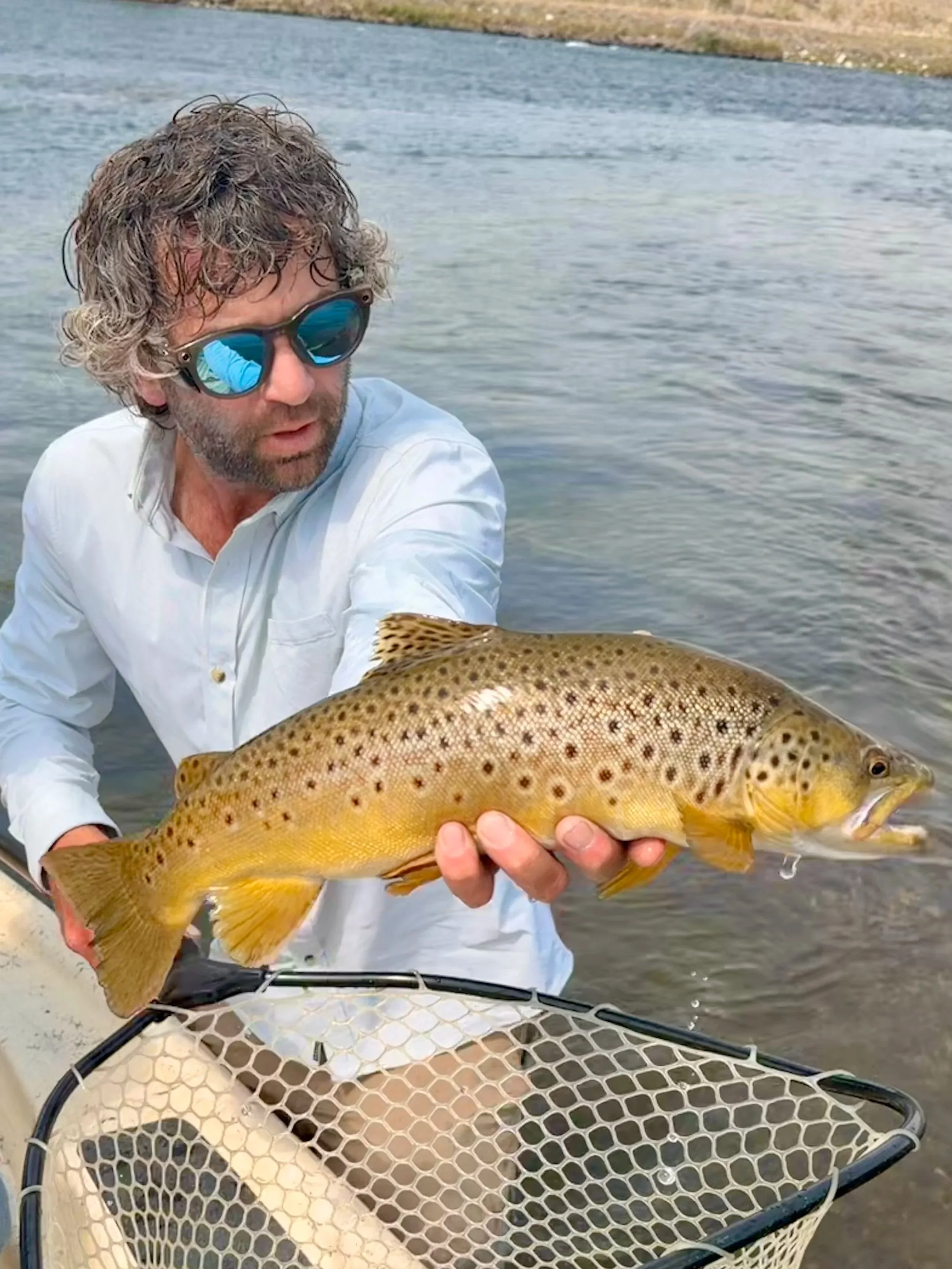 Flyshot Outfitters owner David Kern holding a wild brown trout caught near Varney Bridge on the Madison River.