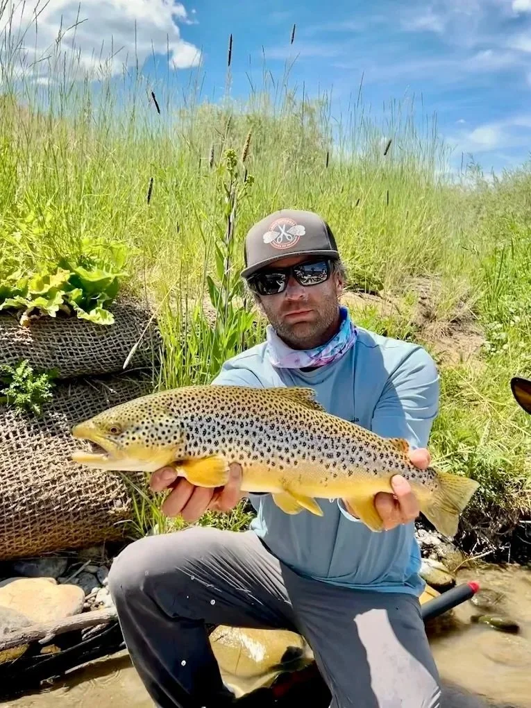 Flyshot Outfitters owner David Kern with a wild Madison River brown trout caught during a spring fly fishing trip near Bozeman, Montana.