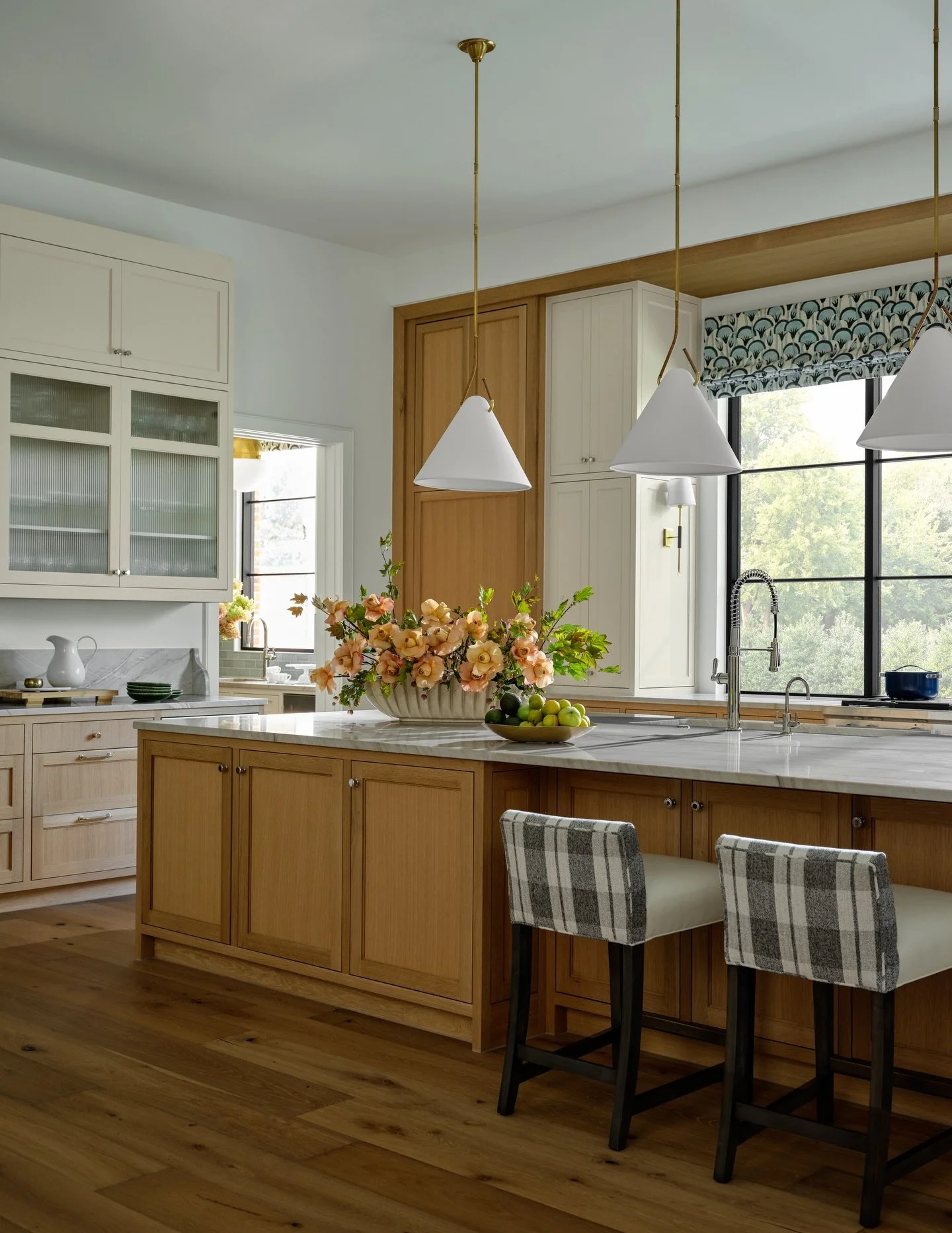 The big moments get the attention, but the magic is in the layers. Rugs, art, window treatments, and thoughtful repeated details are what make a home feel finished and intentional. In this home, we carried the roman shade fabric from the kitchen into