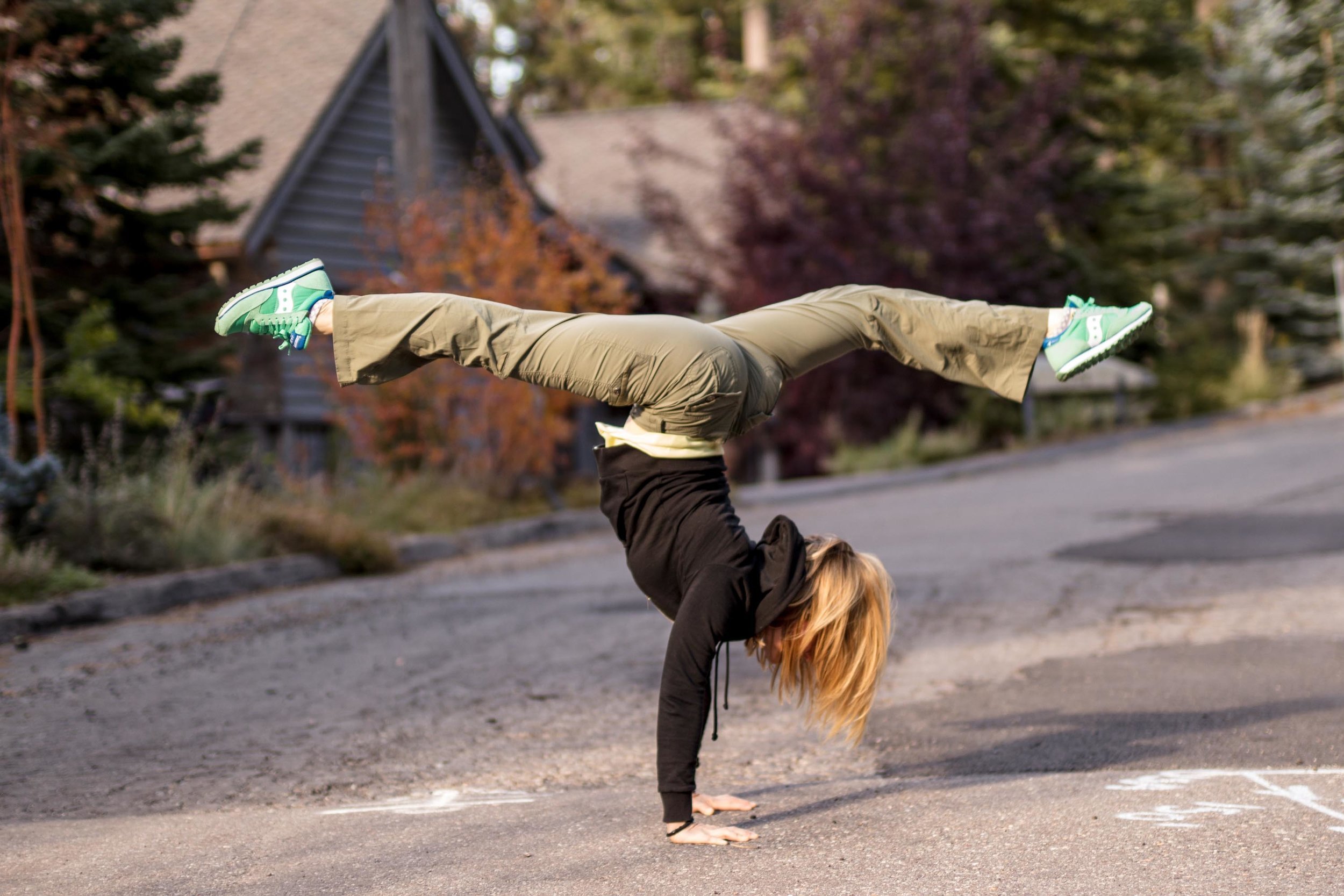 benefits of photography advertising, picture of young lady doing a handstand splits in the middle of a suburb street in sunset
