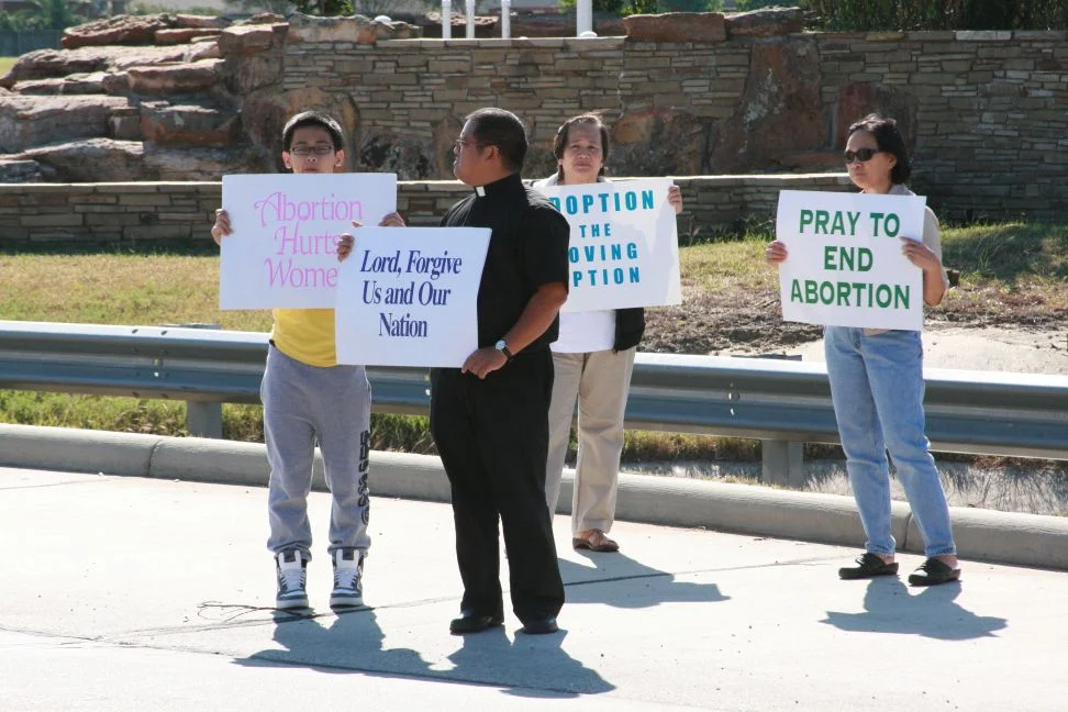 A Priest and a Family Supporting Life