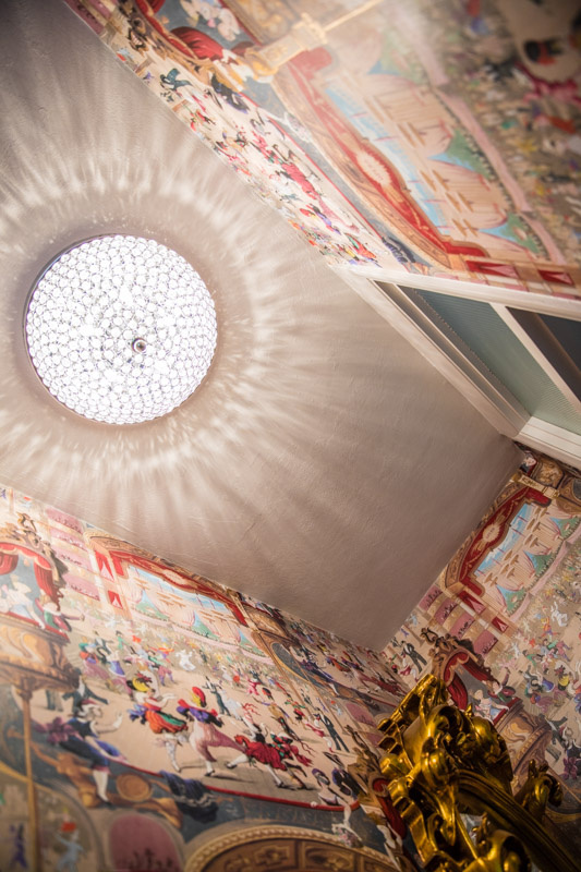 Whimsical cabaret wallpaper Cole and Son in a small powder room