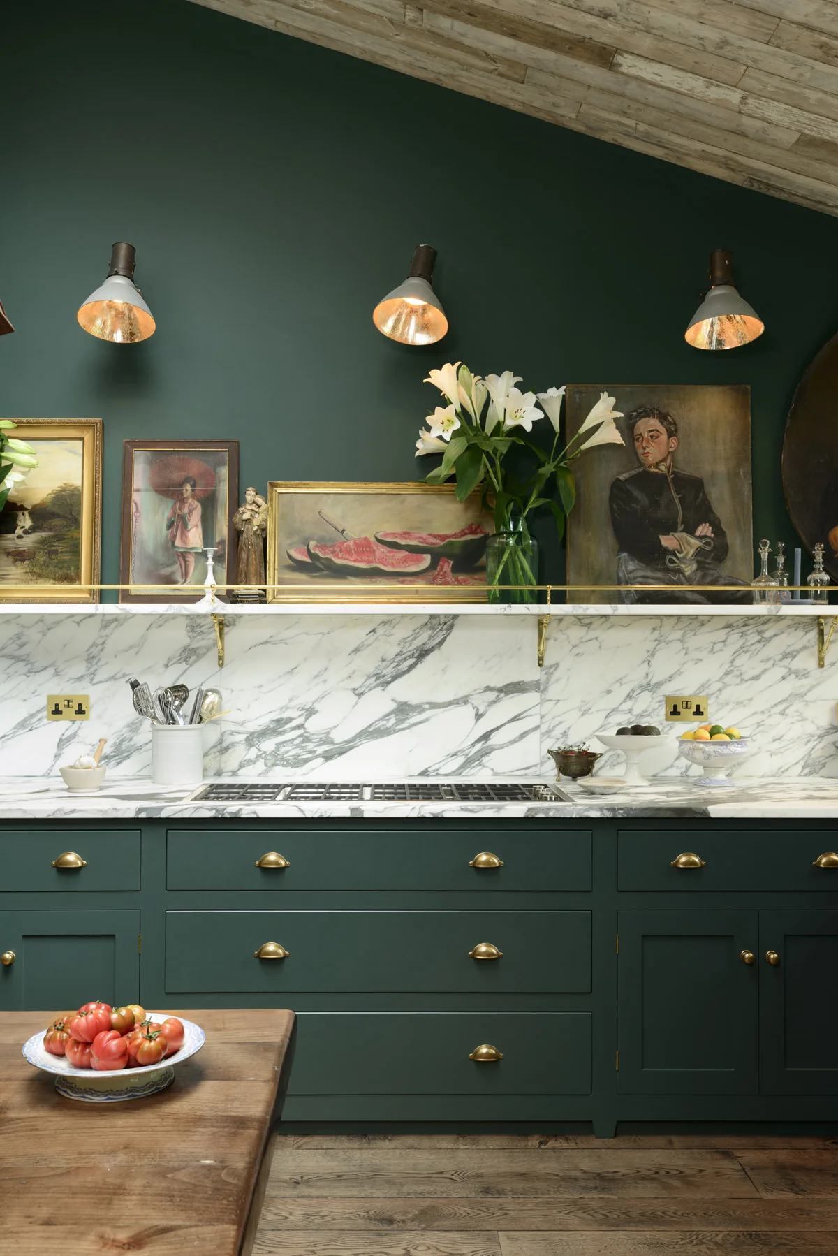 Style and elegance abounds here with the dark green, brass detailing and stunning marble. This is just a dream! Image credit: DeVOL Kitchens
