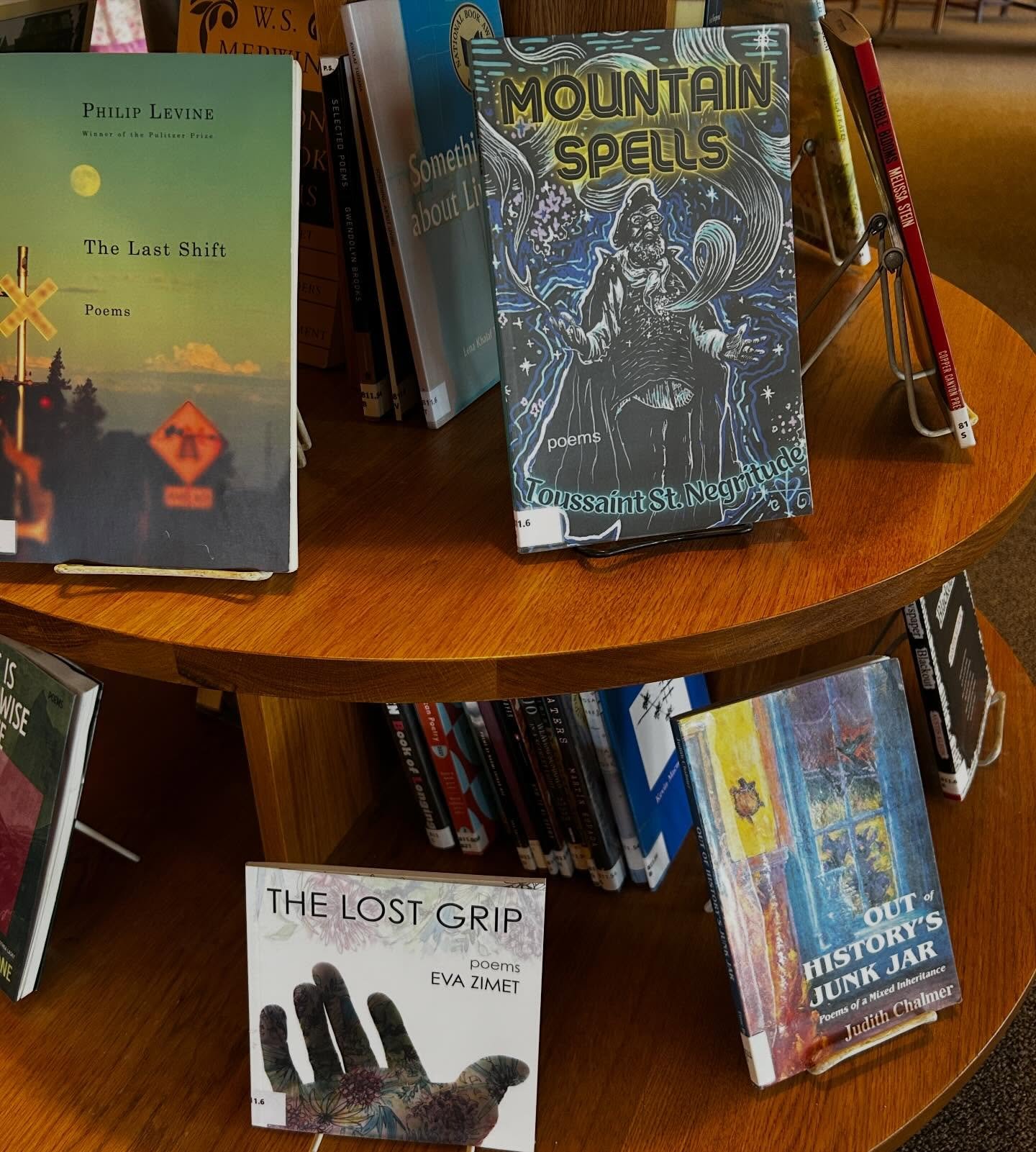 Two Rootstock books on the poetry display at @kellogghubbardlibrary! MOUNTAIN SPELLS by Toussaint St. Negritude @toussaintstnegritude and THE LOST GRIP by Eva Zimet @tango_bent. Check them out and remember to read more #Poetry for #nationalpoetrymont