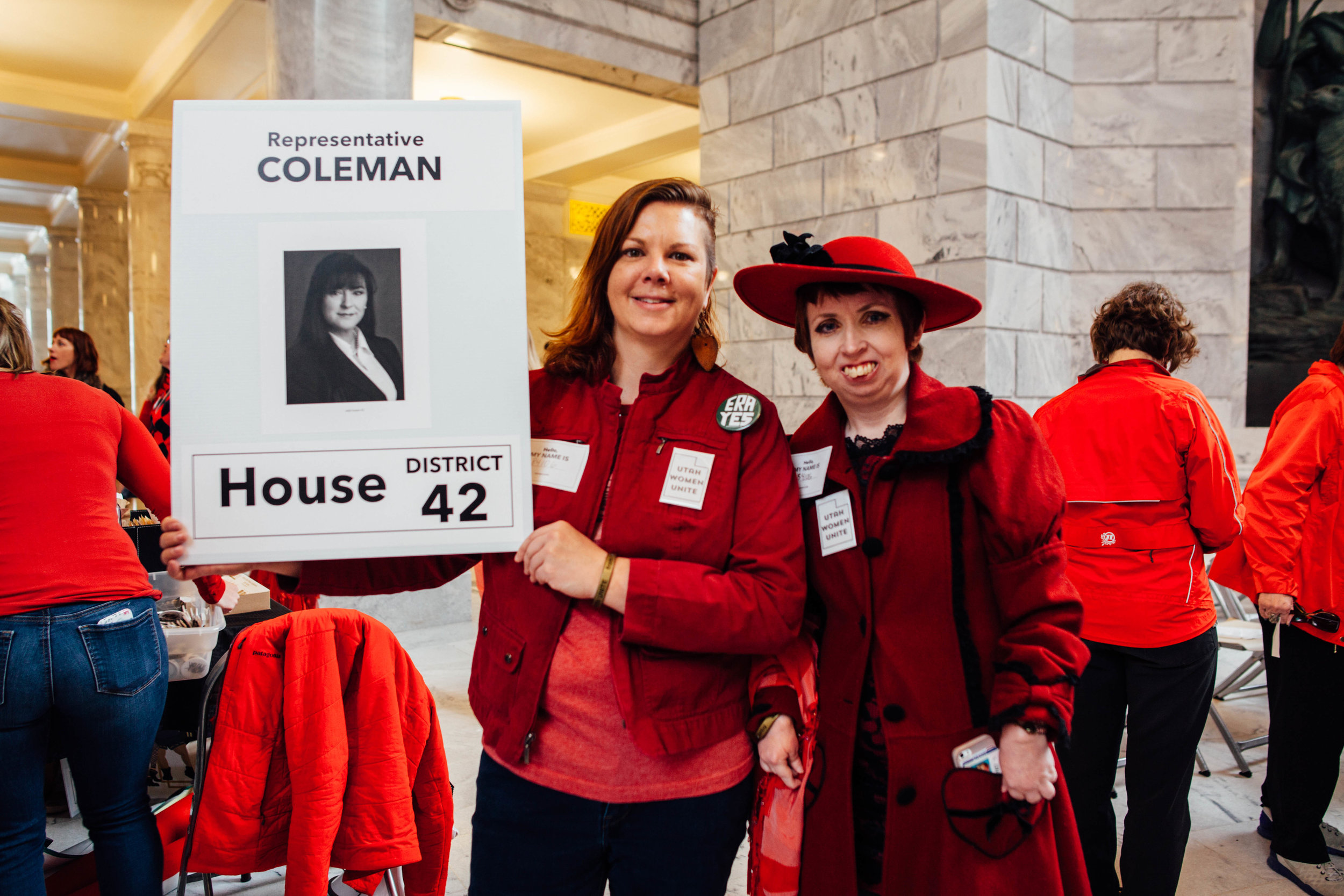 Hillary McDaniel (left), Utah Women Unite's technology director, and Psarah Johnson, Utah Women Unites Caucus Director, (right) wait to speak to Representative Kim F. Coleman. They are not Coleman's constituents, yet they wish to speak to her about her stance on women's rights. McDaniel once stapled ten blank pages together and passed them out to representatives, like Coleman, and said that these pages were their research for false abortion claims. 