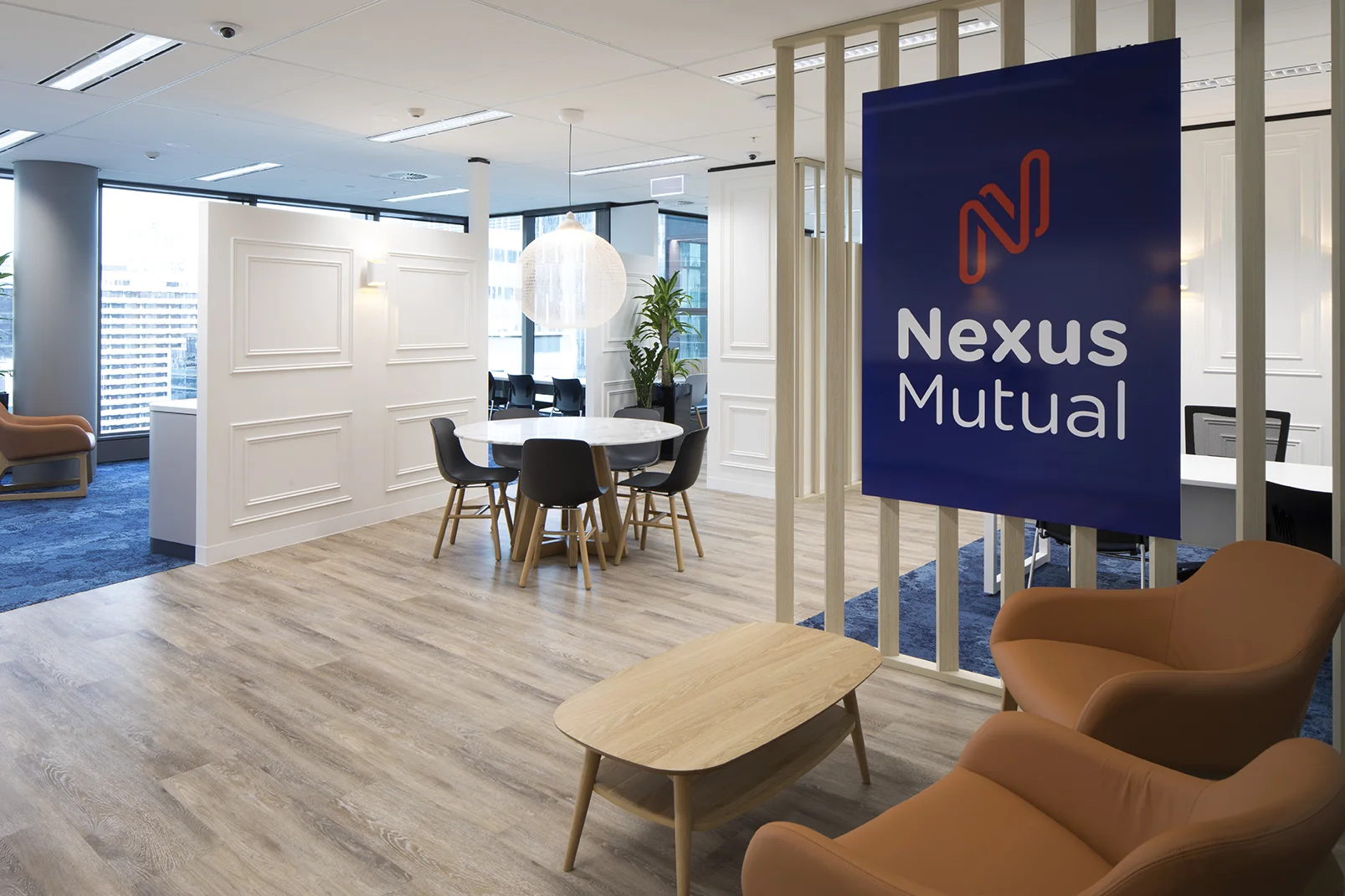 The Nexus Mutual Office fitout features wood panelling, lounge and breakout areas as well as a private members lounge. 