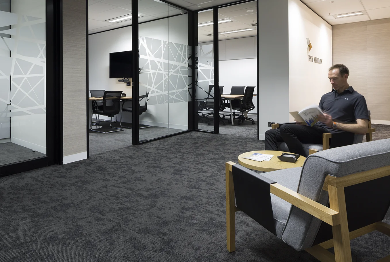 Tall Architects director Shane Wintershoven demontrating the lounge areas at BNY Mellon in the Melbourne CBD.