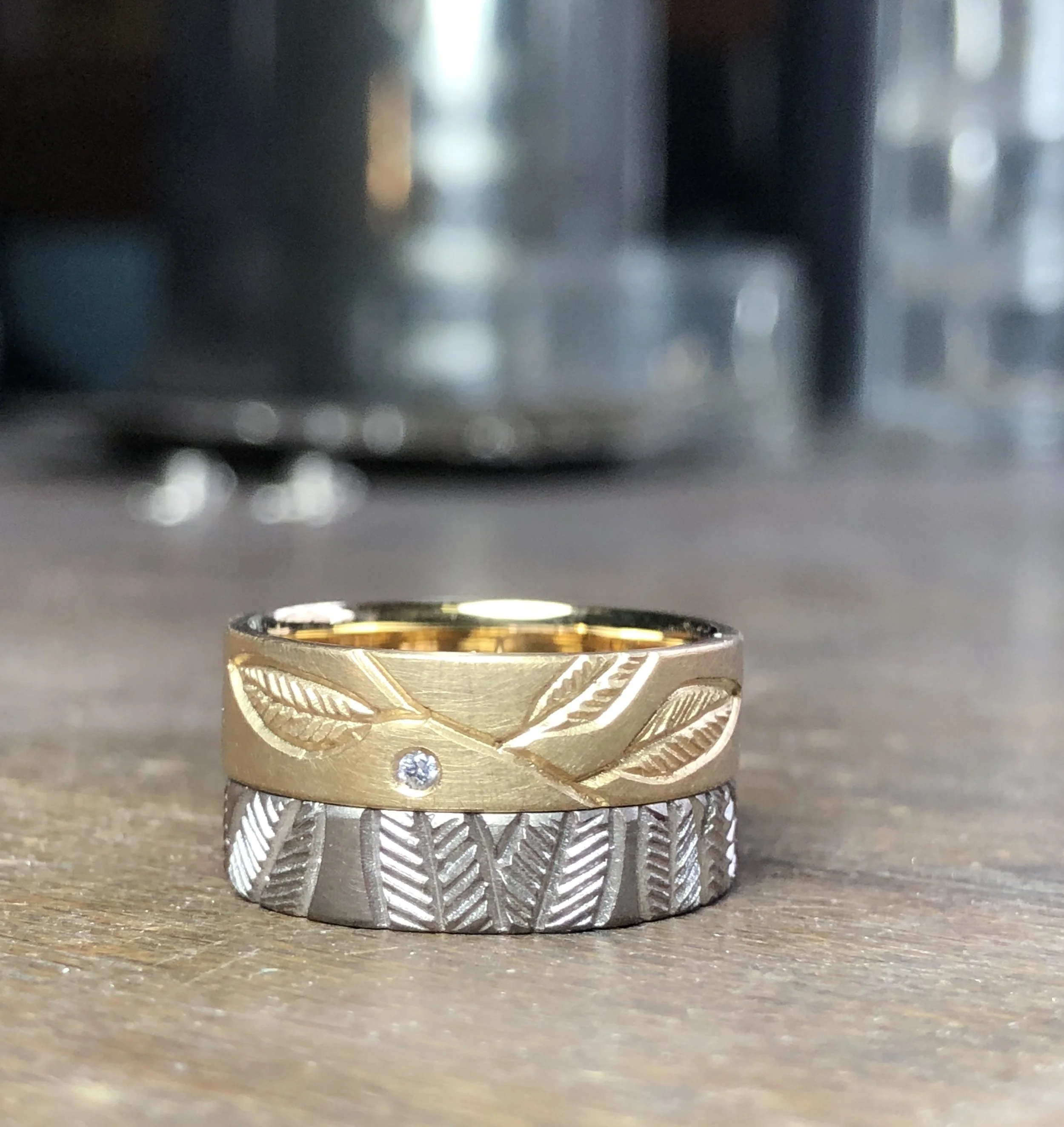 18ct yellow gold band with leaf engraving and 1.5mm white diamond Fsi1. width 5.3mm, thickness 1.4mm, size M. $1380 18ct white gold band with leaves all around the band. width 4.2mm, thickness 1.4mm, size L1/2. $1150 