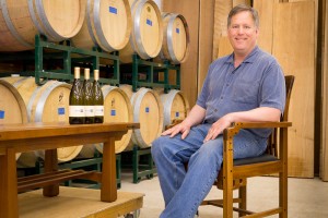 Image of Tom Stangeland sitting in his barrel room at Cloudlift Cellars.