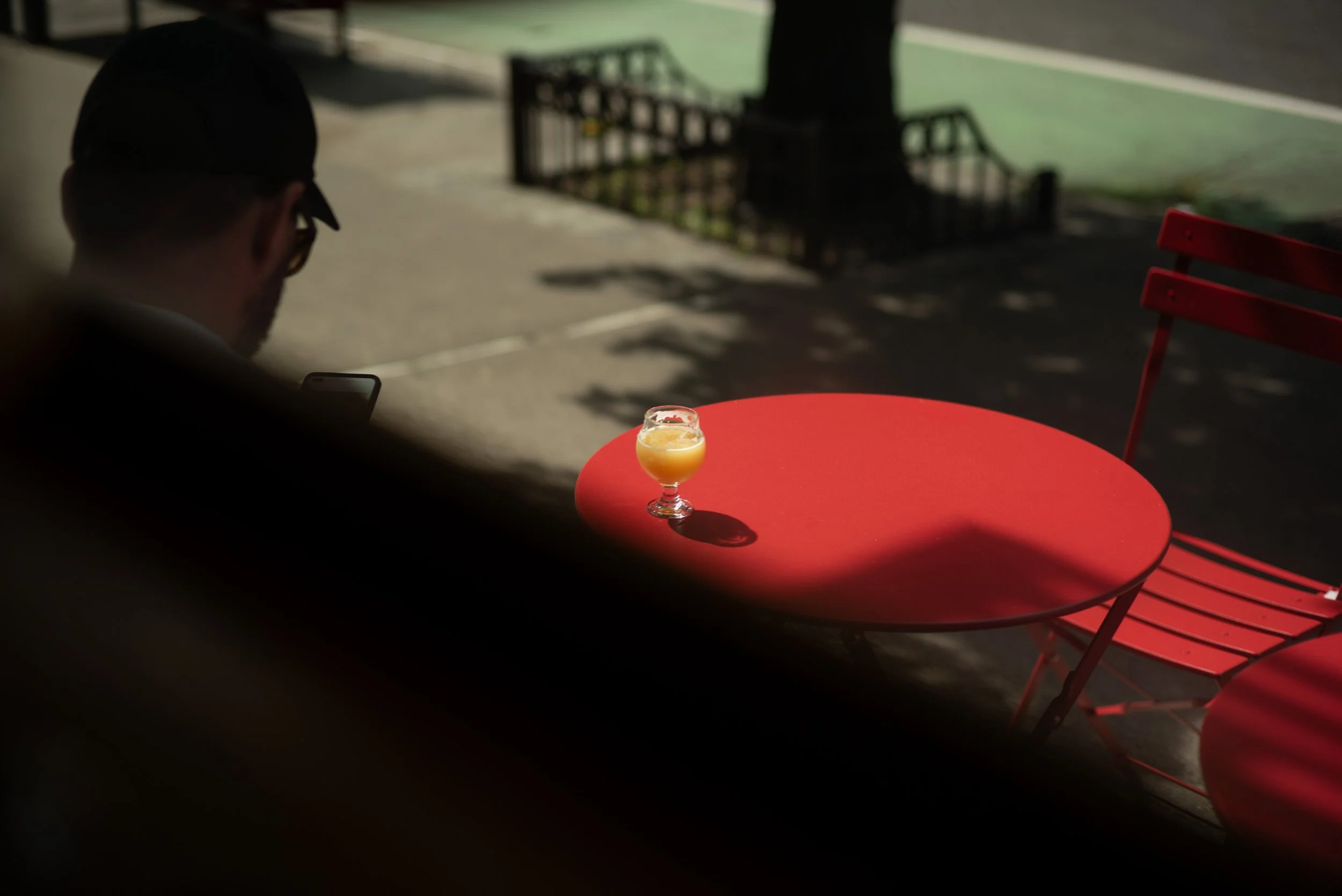Red Table & Sunlight — NYC Street Moment | Chris T. Ramos