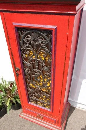 CHINESE INSPIRED RED DISPLAY CABINET $650 NZD   A VIBRANT RED SHABBY CHIC DISPLAY CABINET. WROUGHT IRON PANELING ON DOOR. YELLOW SHELVES TO DISPLAY YOUR HOMEWARES.  DIMENSIONS: 1460MM HIGH, 605MM WIDE, 450MM DEEP  FIRST SHELF AT 310MM SECOND SHELF AT 320MM THIRD SHELF AT 400MM AND THE DRAW 330X395MM INTERNAL