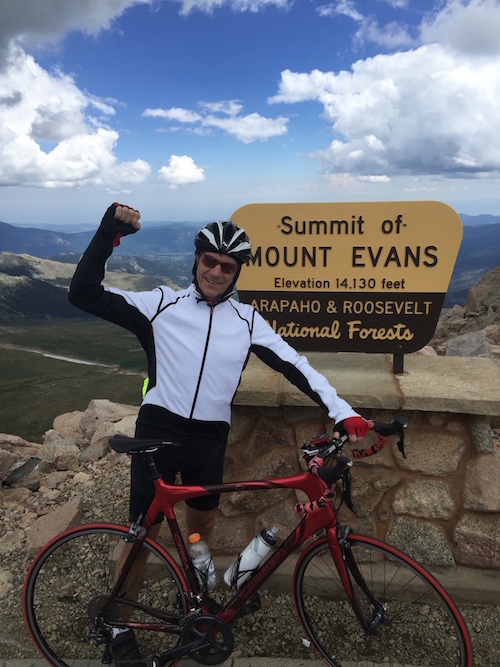 Martin Holland at the summit of Mount Evans elevation 14,130 feet on his long-distance bicycle ride