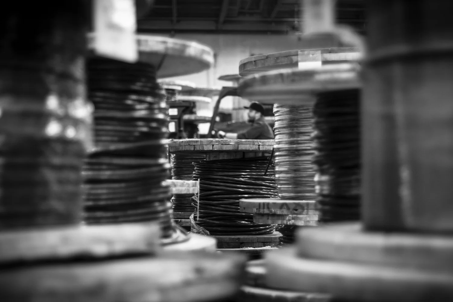 Worker operating a forklift among cable spools in a warehouse, from Martin Holland of Anneal Business Coaching's article "How to Talk to Prospective Investors.