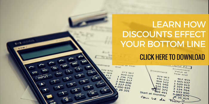 Free discount calculator download from Martin Holland at Anneal Business Coaching, showing a calculator on financial papers with the text "Learn how discounts affect your bottom line. Click here to download.