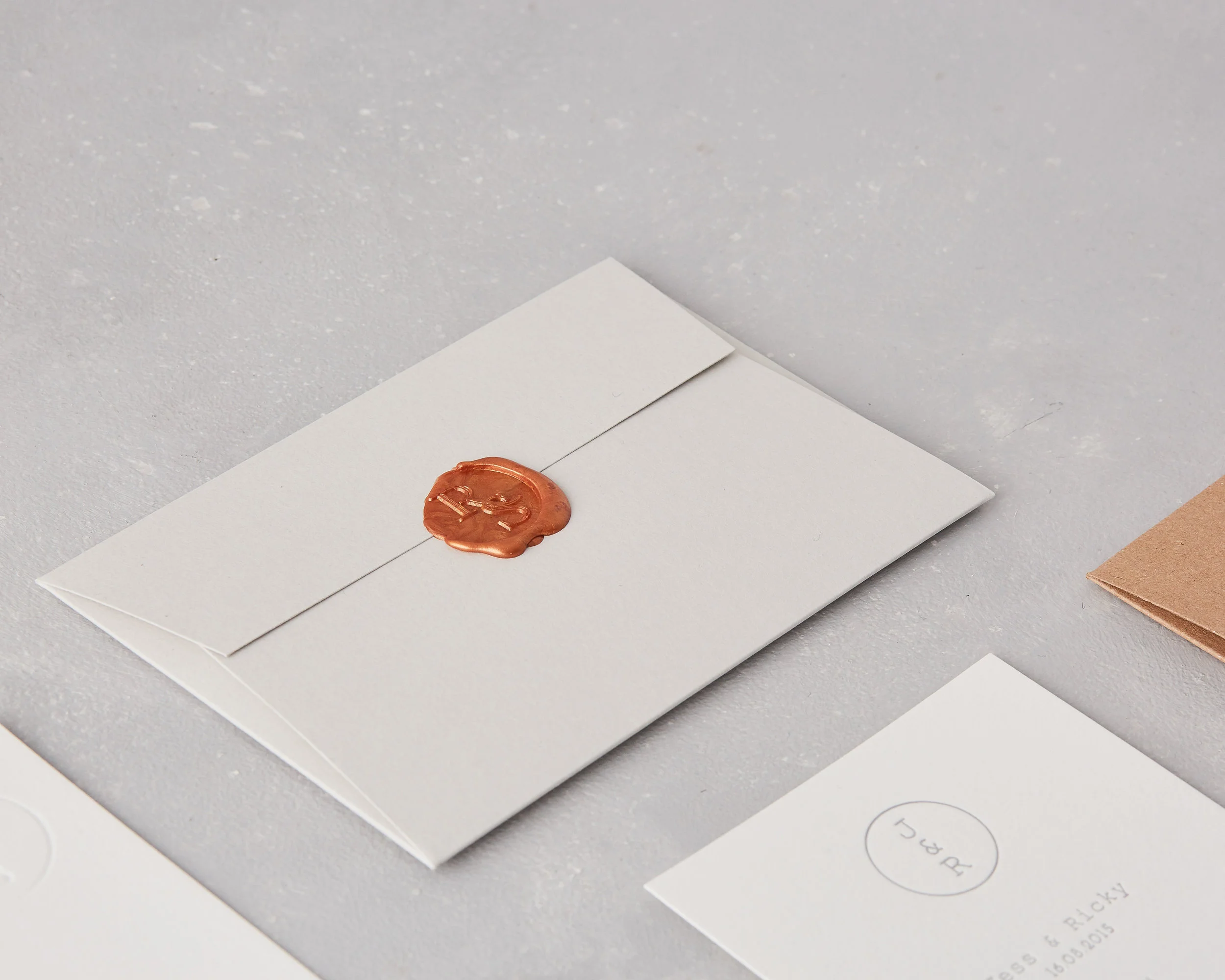 Copper wax seal wedding monogram on grey envelope