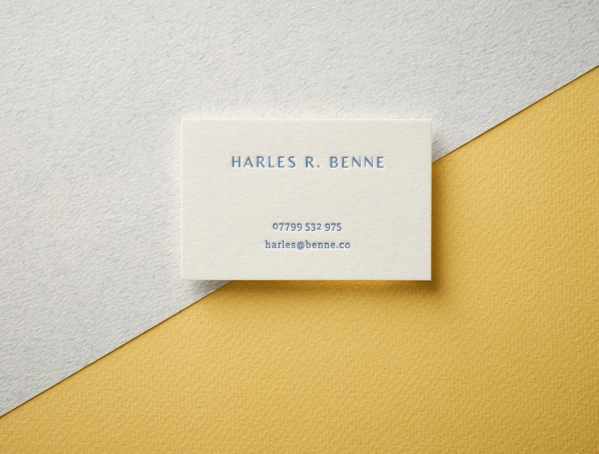 Blue letterpress business card printed with deep debossed impression