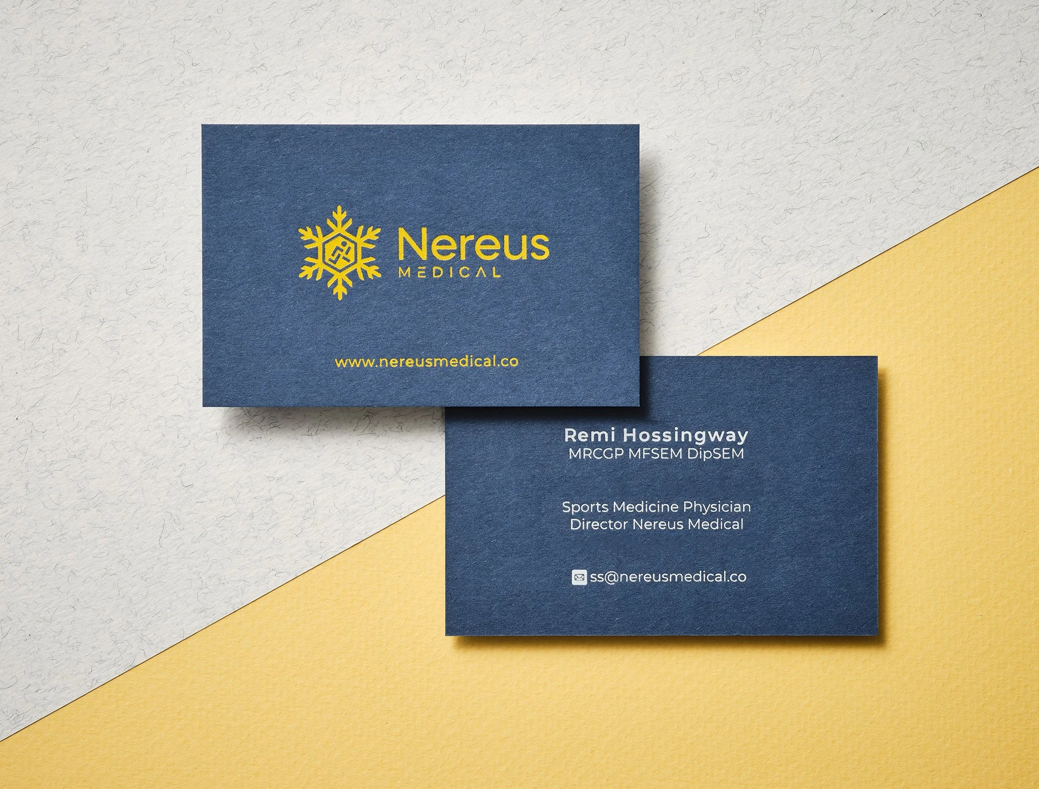 Blue business card printed with white and yellow matt foil on thick coloured stock
