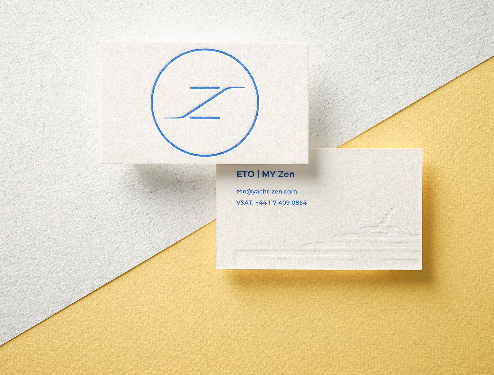 Letterpress business card with blue ink and blind debossed yacht illustration on thick white uncoated stock
