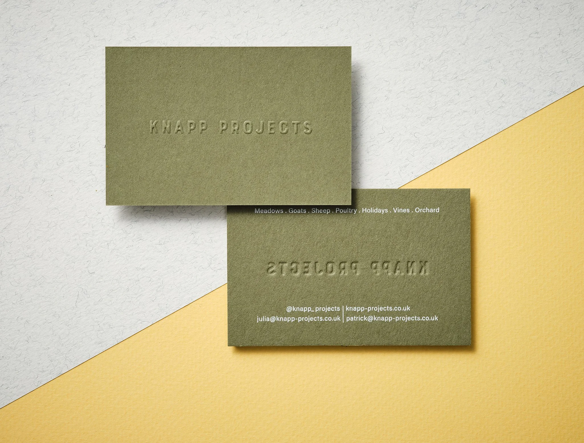 A blind embossed business card with textured logo pressed through to create an embossed texture on front and back, created by Wolf & Ink