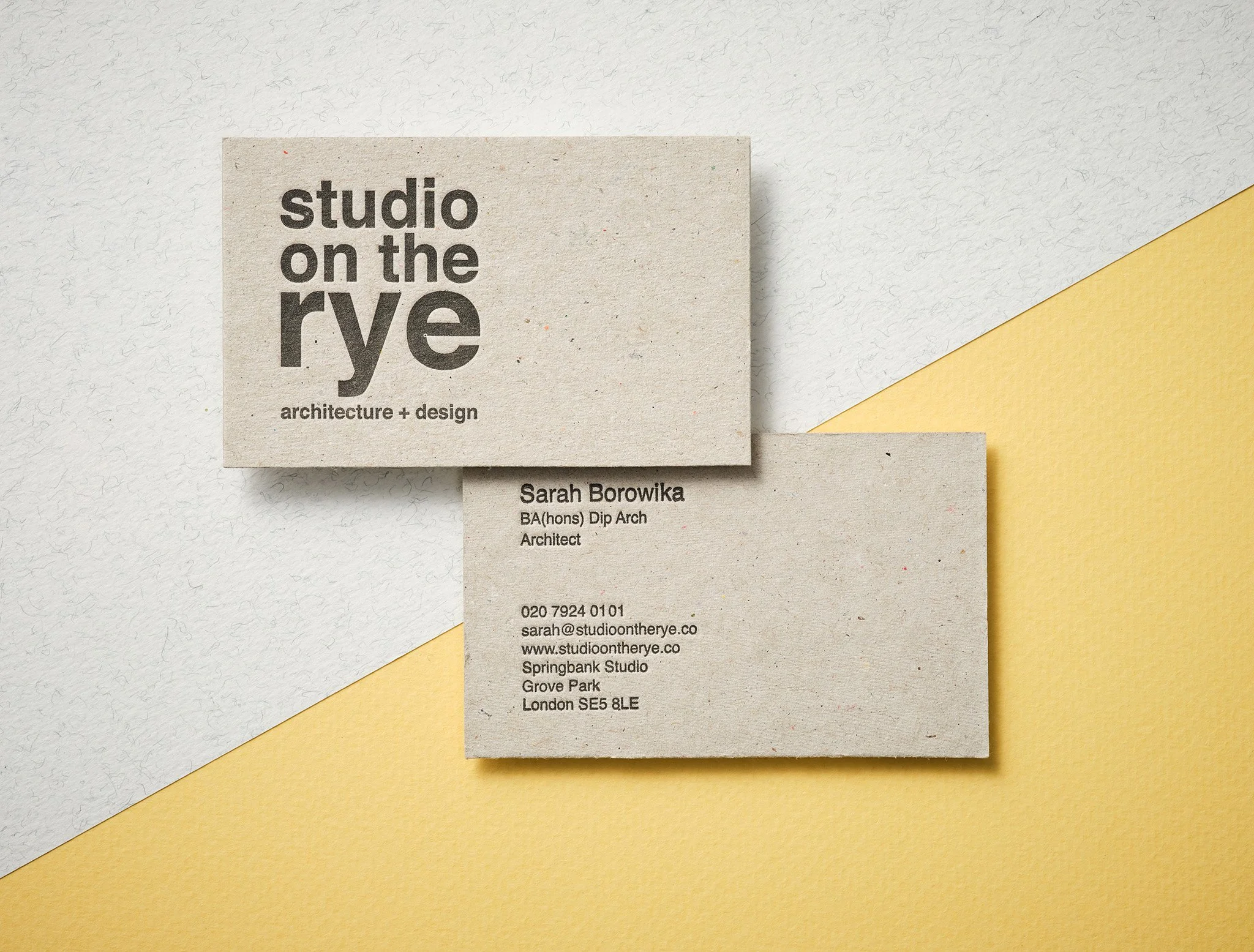 Recycled letterpress business card printed on greyboard flecked paper with black typography