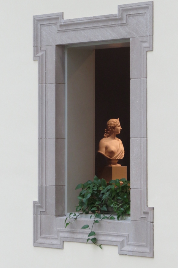 Artwork framed by entry hall windows.