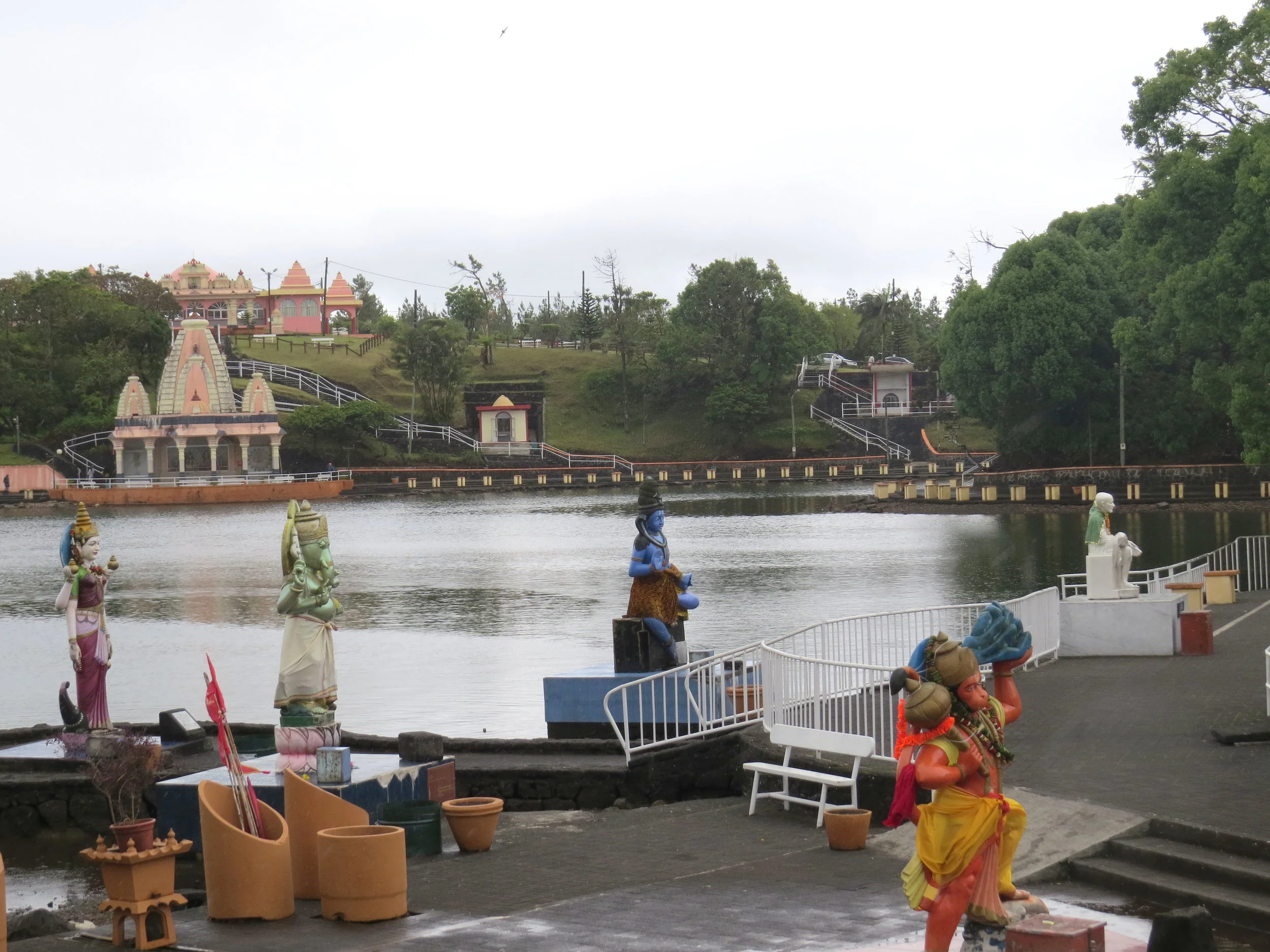  We walked along the lake and came to what we determined was the main temple. There were large statues of Hindu deities scattered along the lake's edge, many with offerings at their feet.