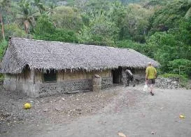 David heads into Sailon's house at Malekula to make solar panel repairs.