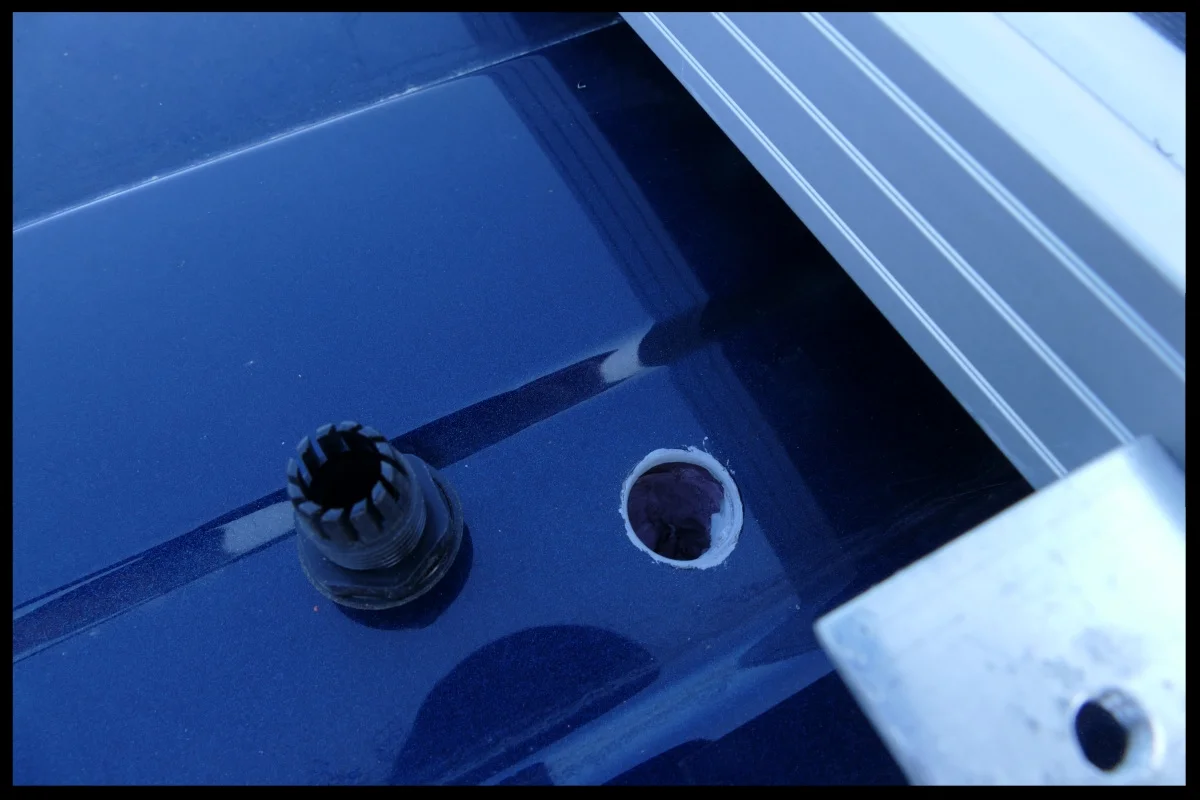 The wire gland next to the primed hole in the roof