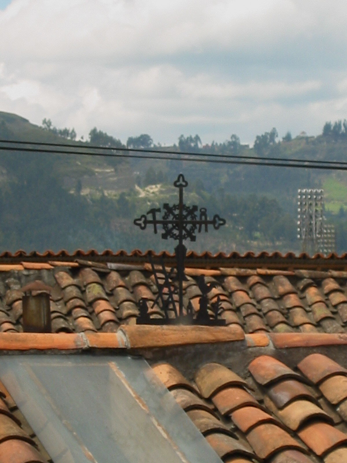 Black wrought iron crosses decorated each red clay rooftop.
