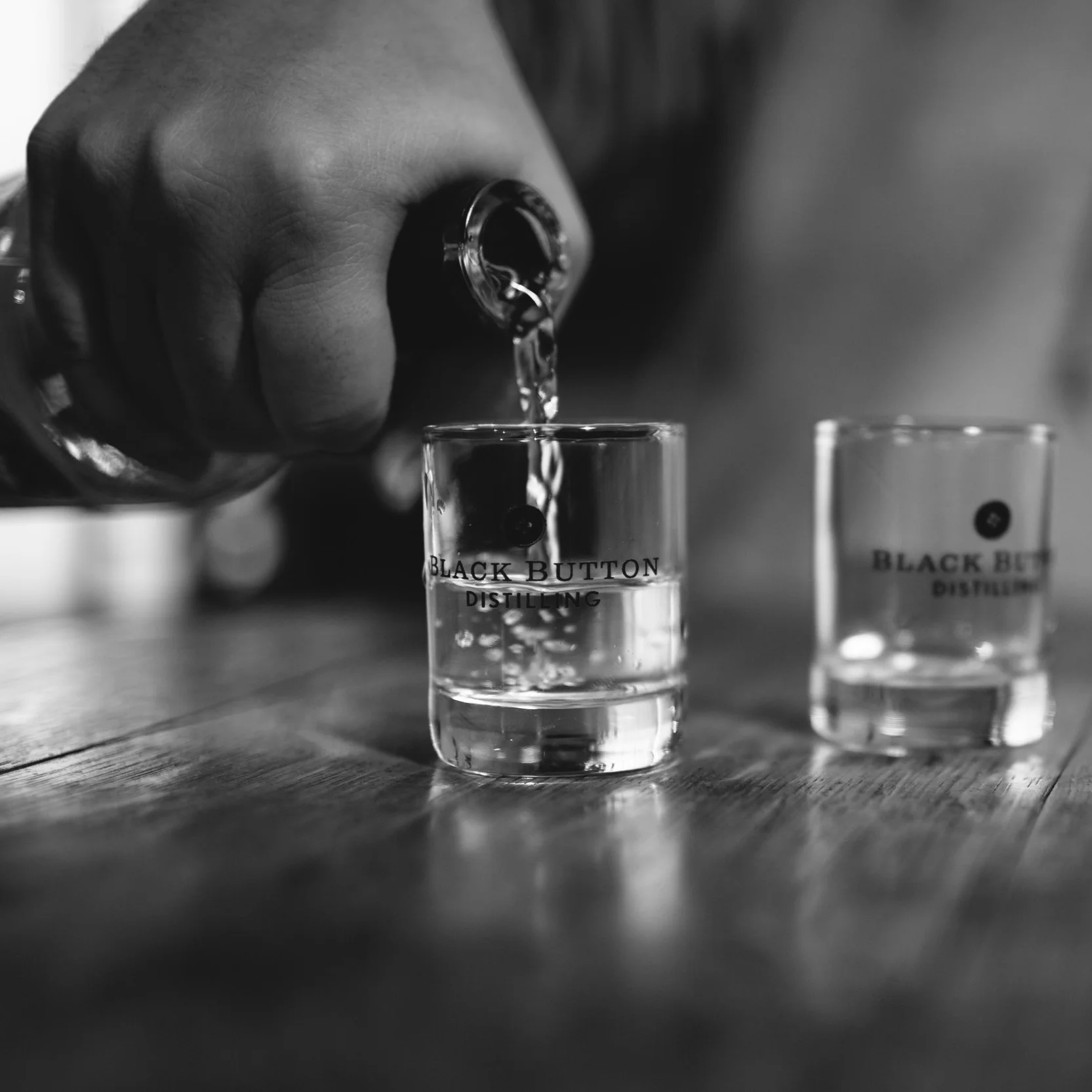 Gin being poured in a Black Button tasting glass