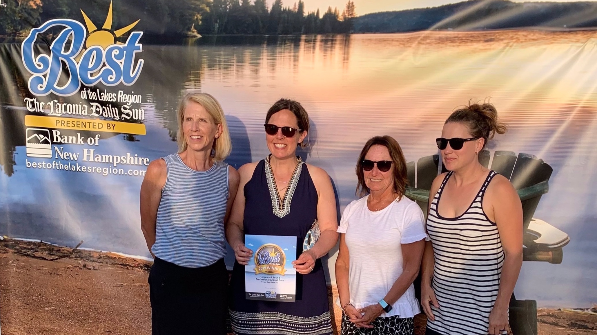 Homeward Bound employees, along with owner Alix, accept Best of the Lakes Region Award at the Best of the Lakes Region Beach Party. From L to R: Jane, Alix, Lee, and Emily.