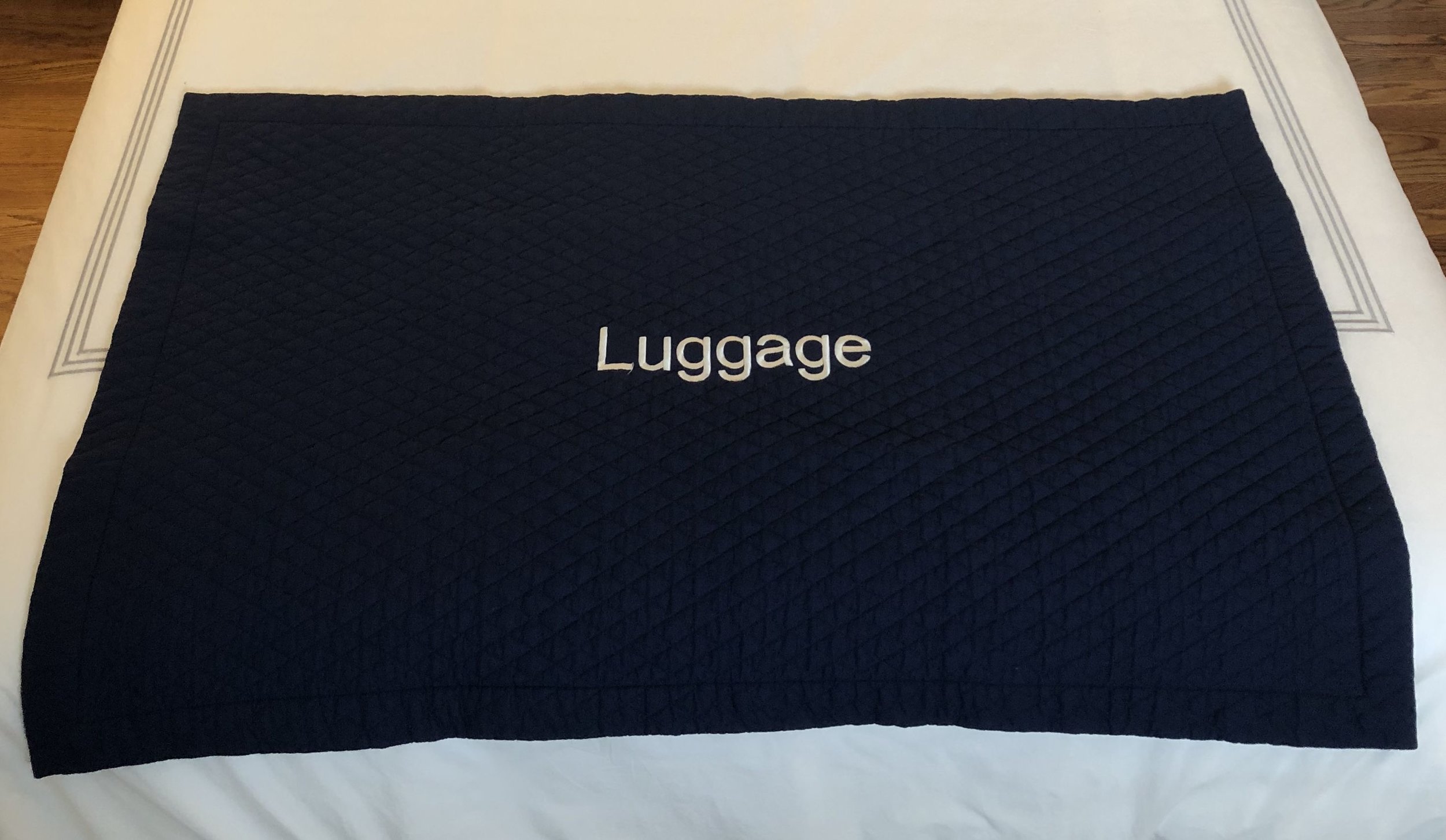  Our cotton quilted luggage mat adds the finishing touch to the cabin or bed, helping to protect your expensive linens from outside bags when guests arrive. Easily machine washable and ironed.    Each mat can be embroidered with the word Luggage or a