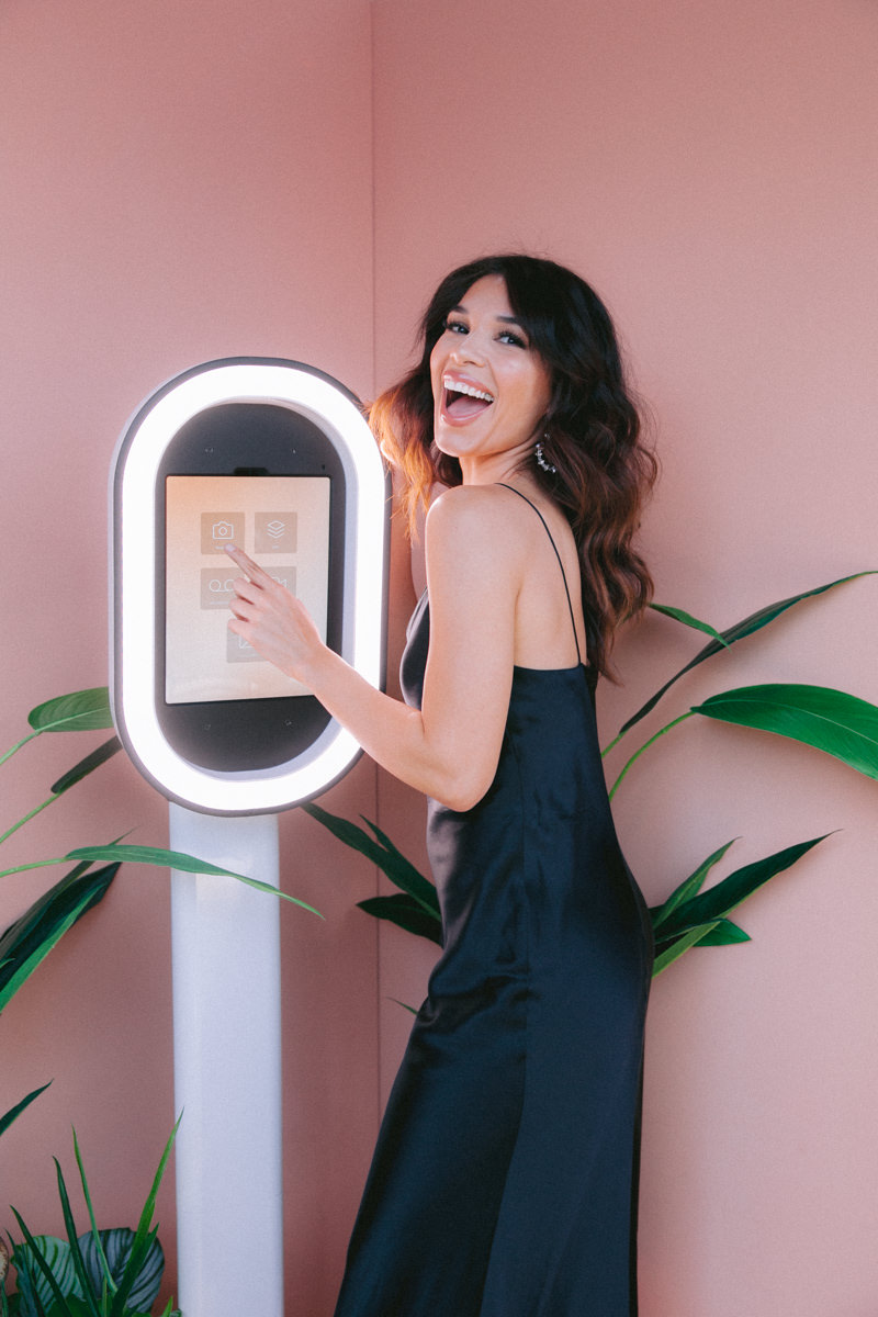 Woman in black dress standing in front of a selfie photo booth, Wedding Photographer, M.A.D. Images, Inc, Tampa, Florida