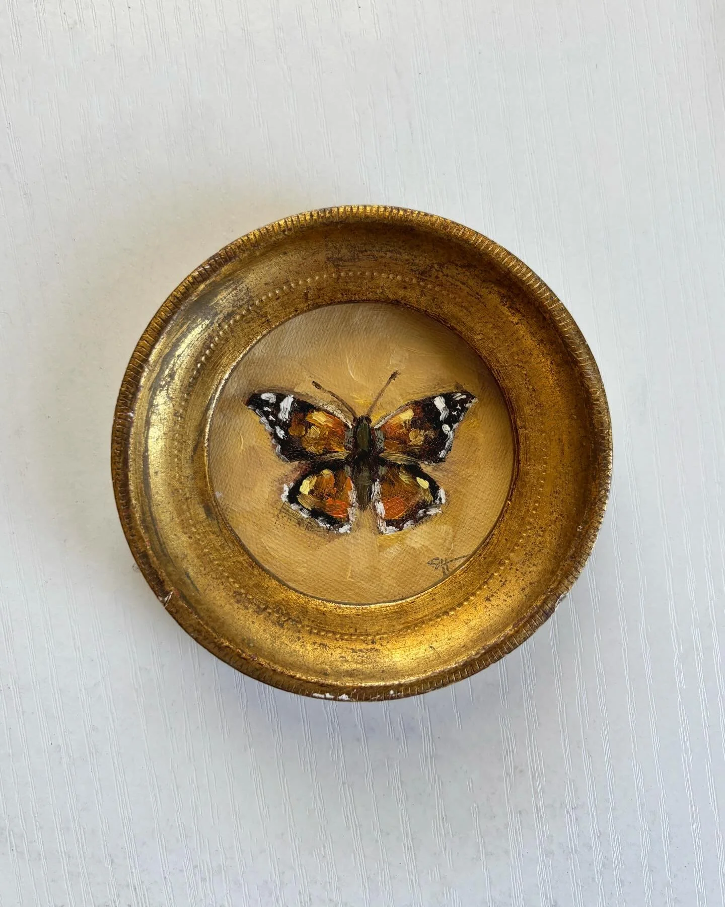 This 🦋 and a few others are in route to @meanscarneyhome ! Swipe to see this painting in action 🎨 tiny tiny oil on linen in a vintage gold frame ready for your walls or shelves.