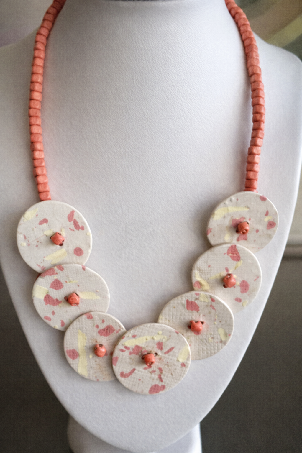 Orange and yellow disk necklace with orange bead chain.png