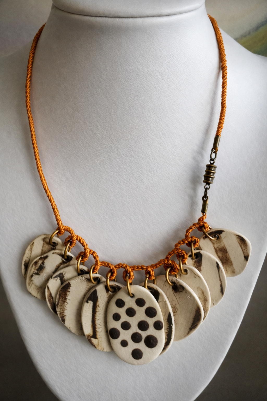 Brown and white necklace with orange silk corded wire.png